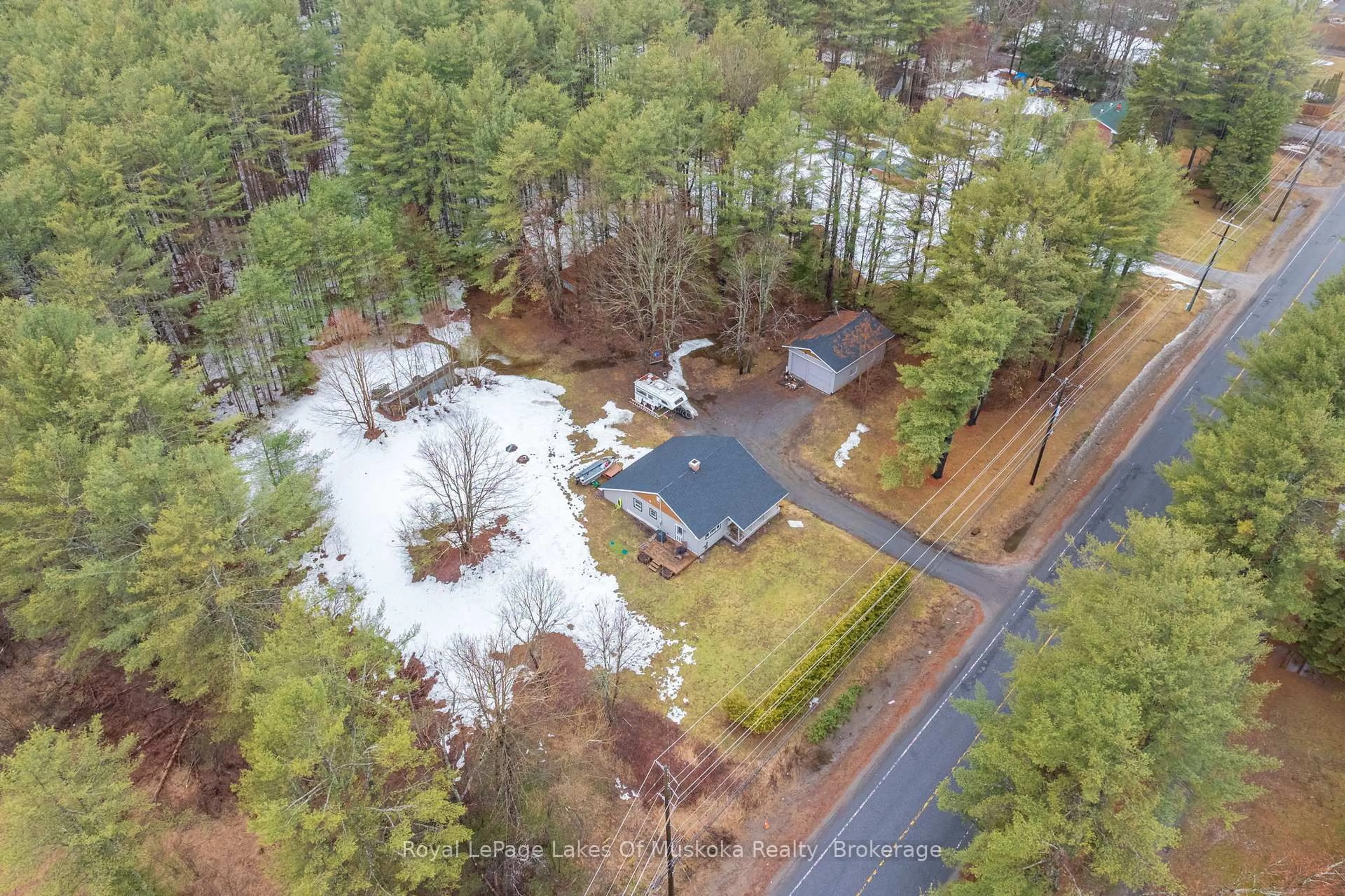 A pic from outside/outdoor area/front of a property/back of a property/a pic from drone, forest/trees view for 1150 Manitoba St, Bracebridge Ontario P1L 0K8