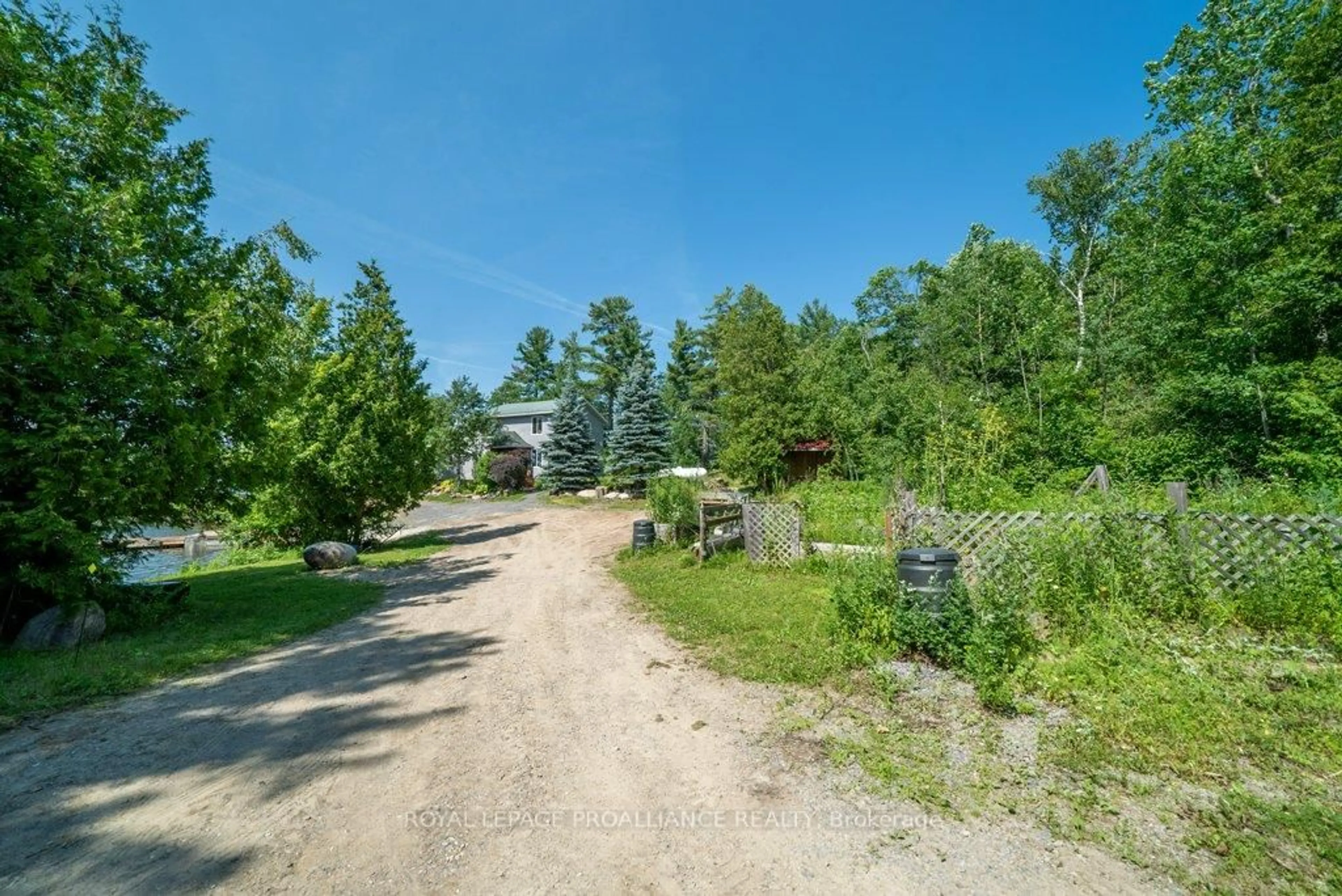 A pic from outside/outdoor area/front of a property/back of a property/a pic from drone, forest/trees view for 2475 Alfs Bay Lane, Arden Ontario K0H 1B0