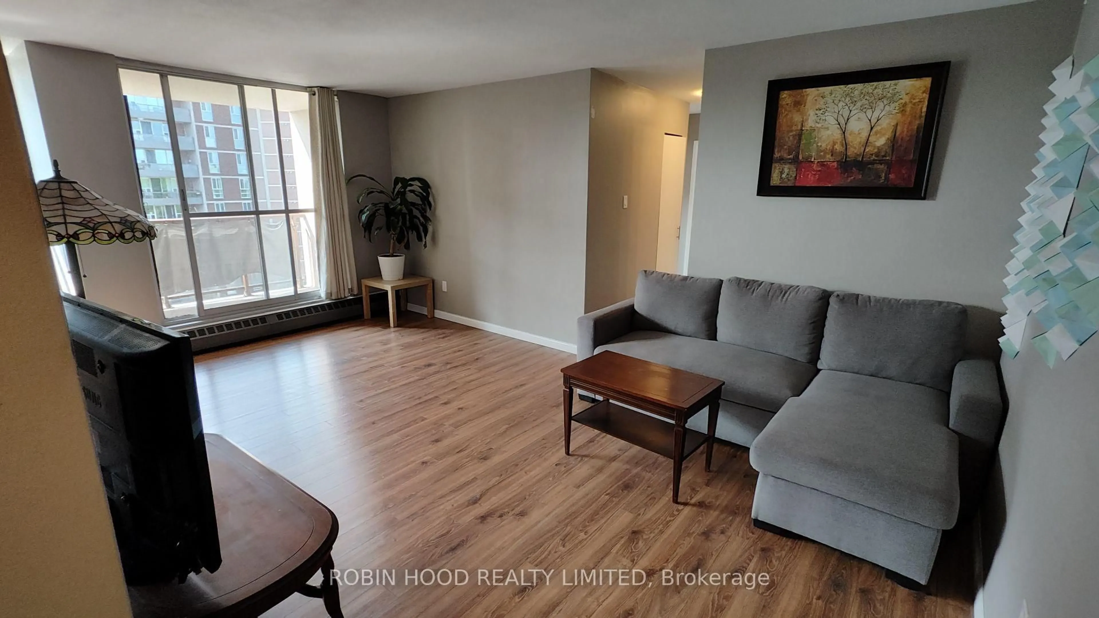 Living room with furniture, wood/laminate floor for 1950 Main St #705, Hamilton Ontario L8S 4M9