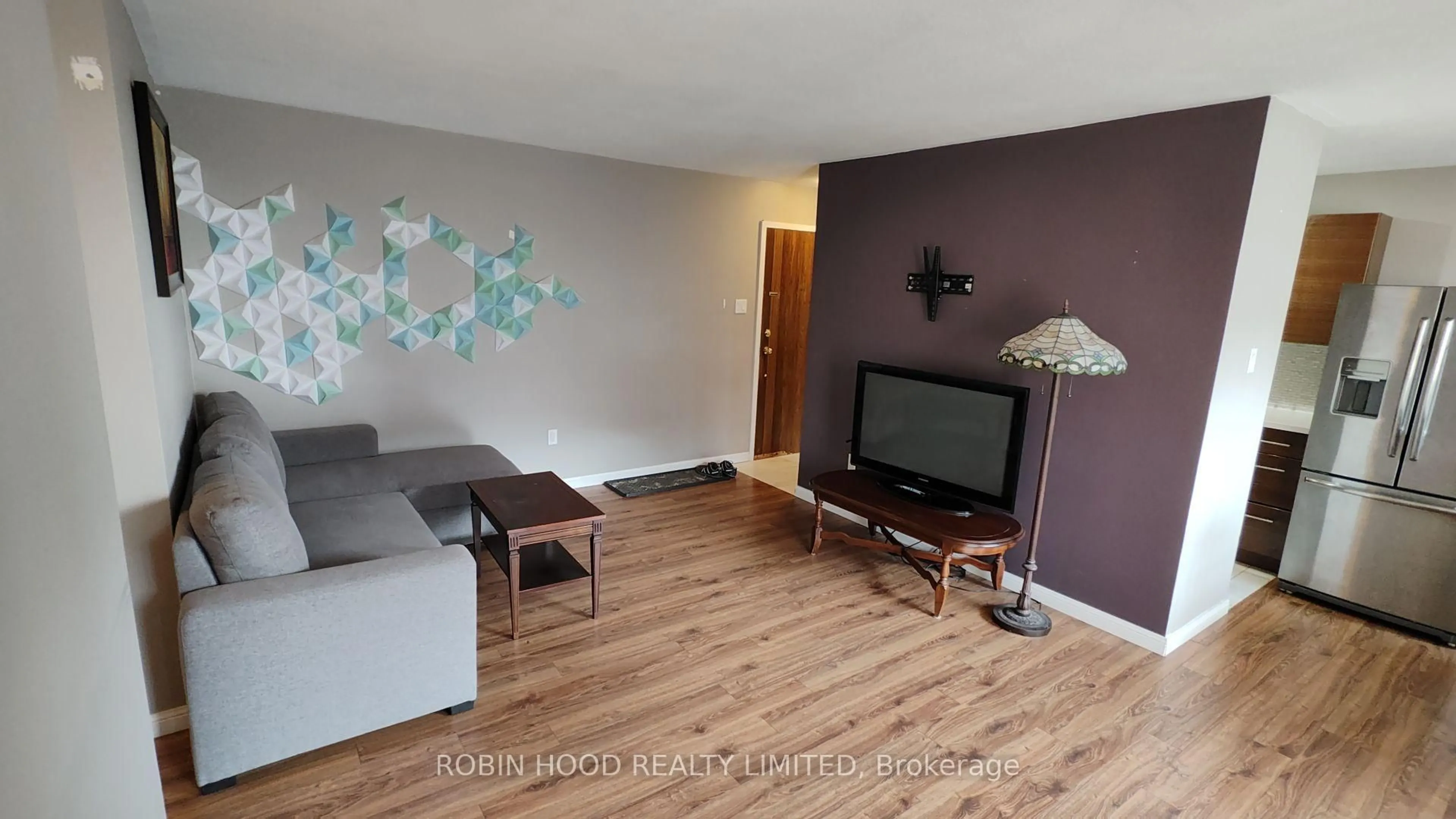 Living room with furniture, wood/laminate floor for 1950 Main St #705, Hamilton Ontario L8S 4M9
