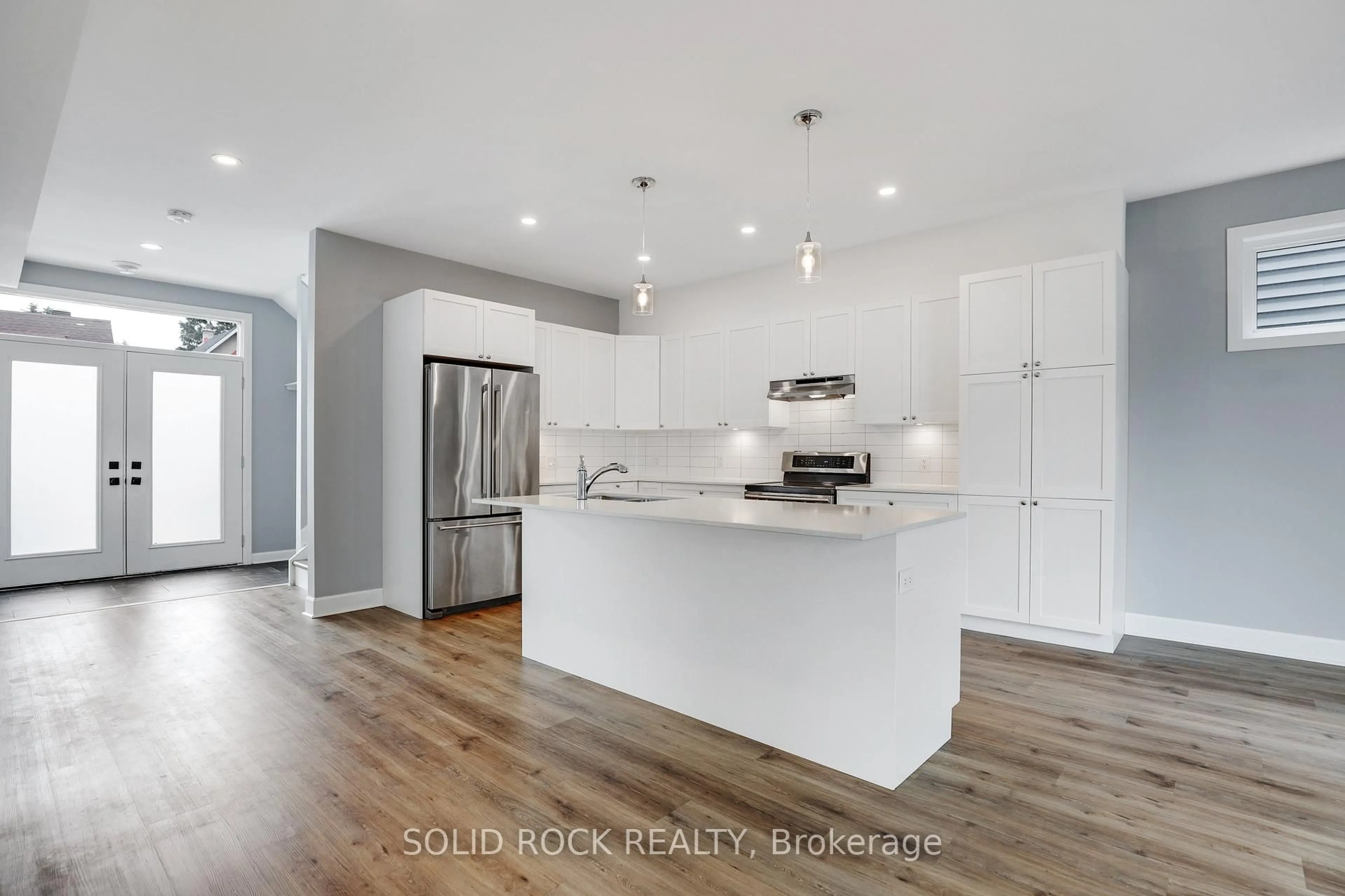 Open concept kitchen, wood/laminate floor for 144 Montfort St, Ottawa Ontario K1L 5P6