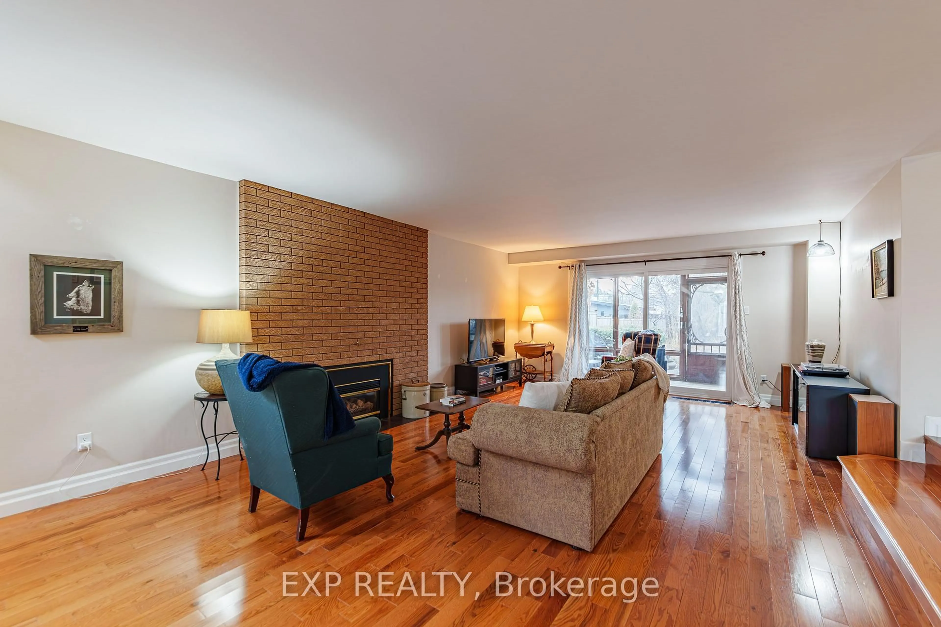 Living room with furniture, wood/laminate floor for 1592 Apeldoorn Ave, Ottawa Ontario K2C 1V5