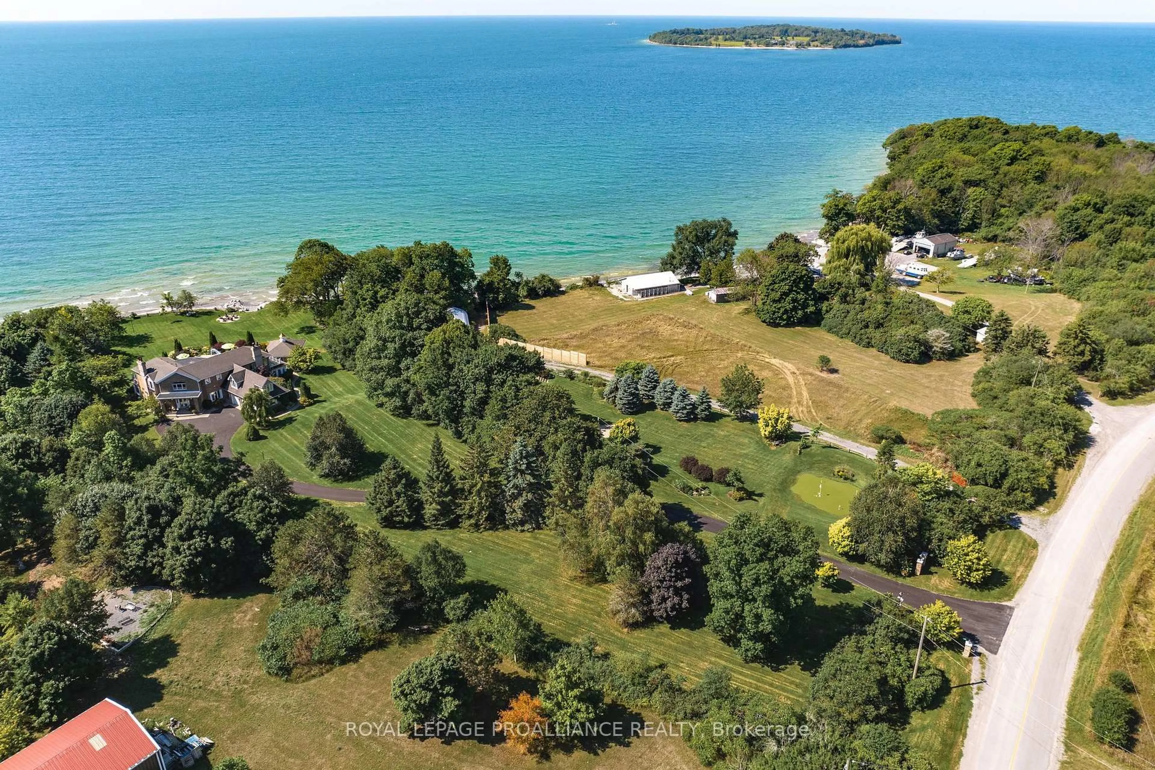 A pic from outside/outdoor area/front of a property/back of a property/a pic from drone, water/lake/river/ocean view for 1261 County Rd 20, Prince Edward County Ontario K0K 3L0