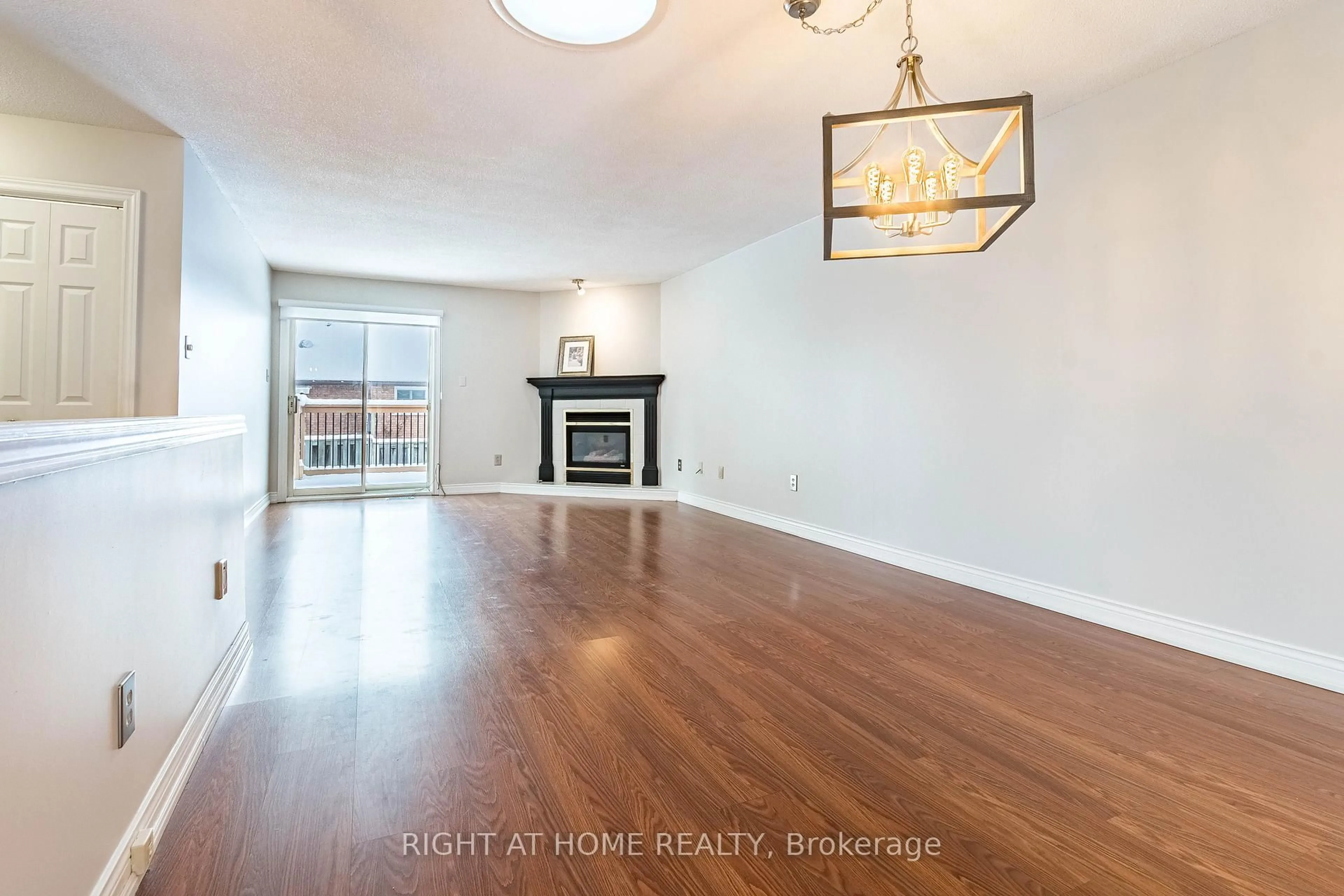 Living room with furniture, wood/laminate floor for 165 Main St #7, Grimsby Ontario L3M 1P2