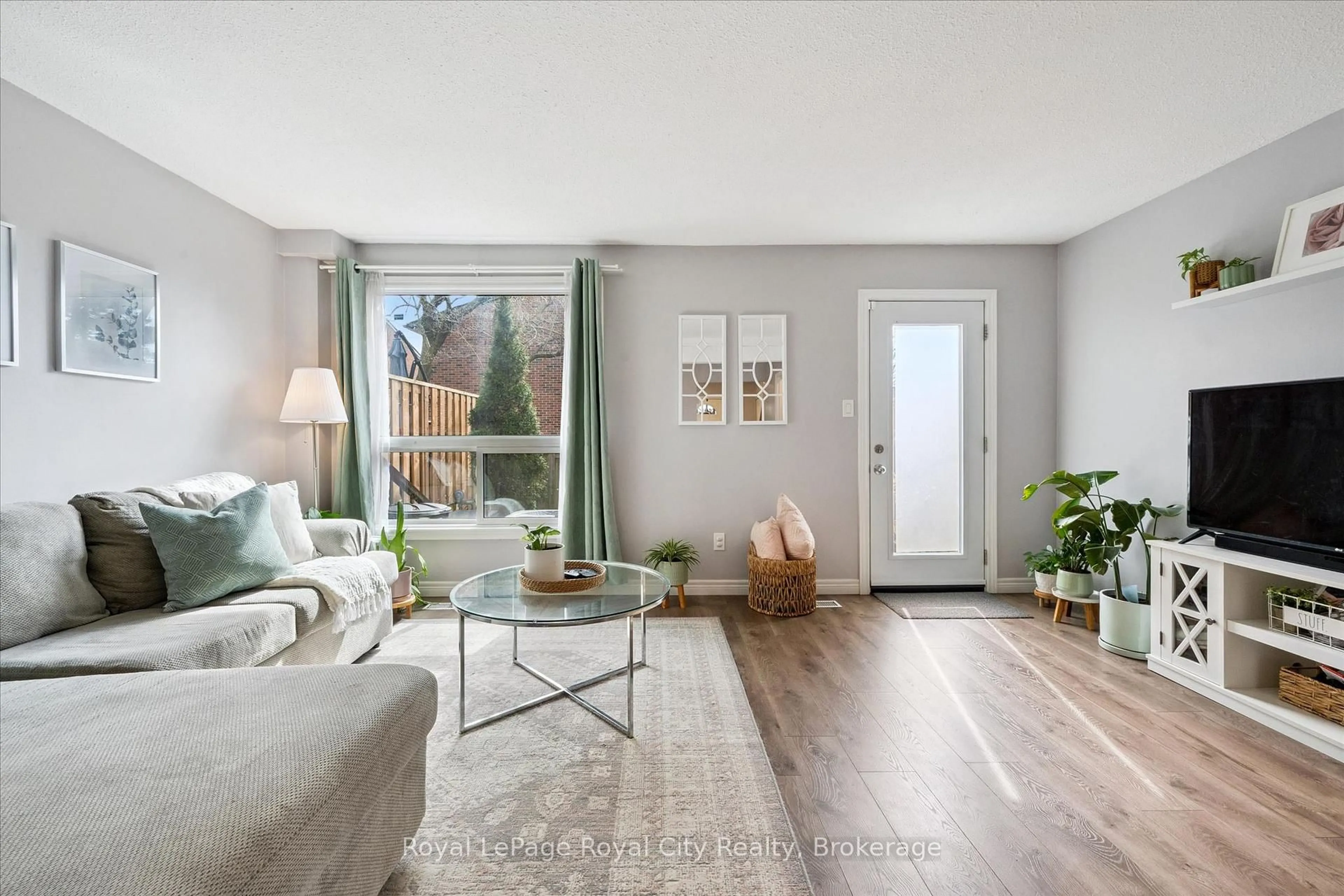 Living room with furniture, wood/laminate floor for 41 Rhonda Rd #23, Guelph Ontario N1H 6H1