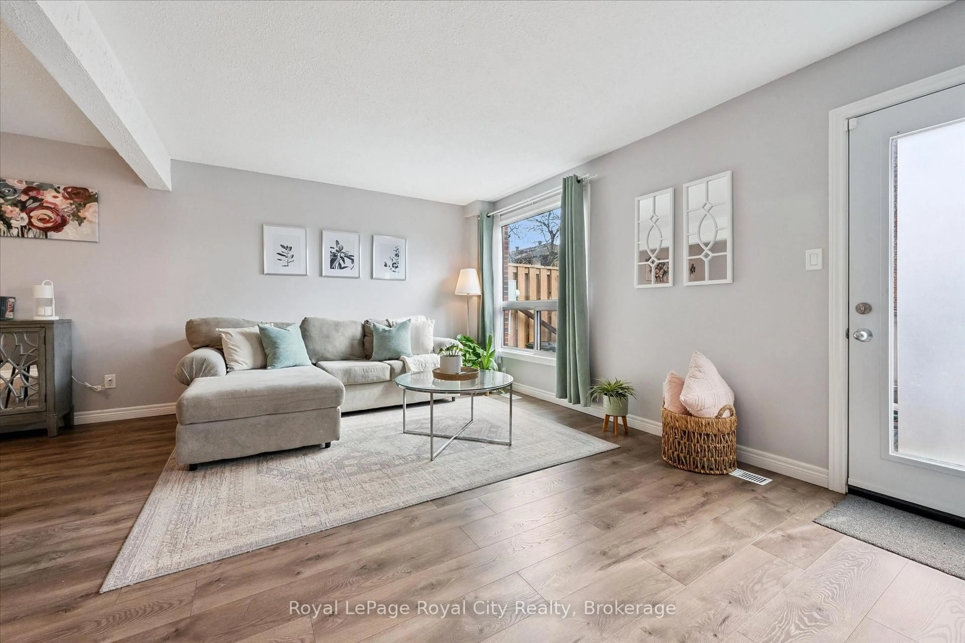 Living room with furniture, wood/laminate floor for 41 Rhonda Rd #23, Guelph Ontario N1H 6H1