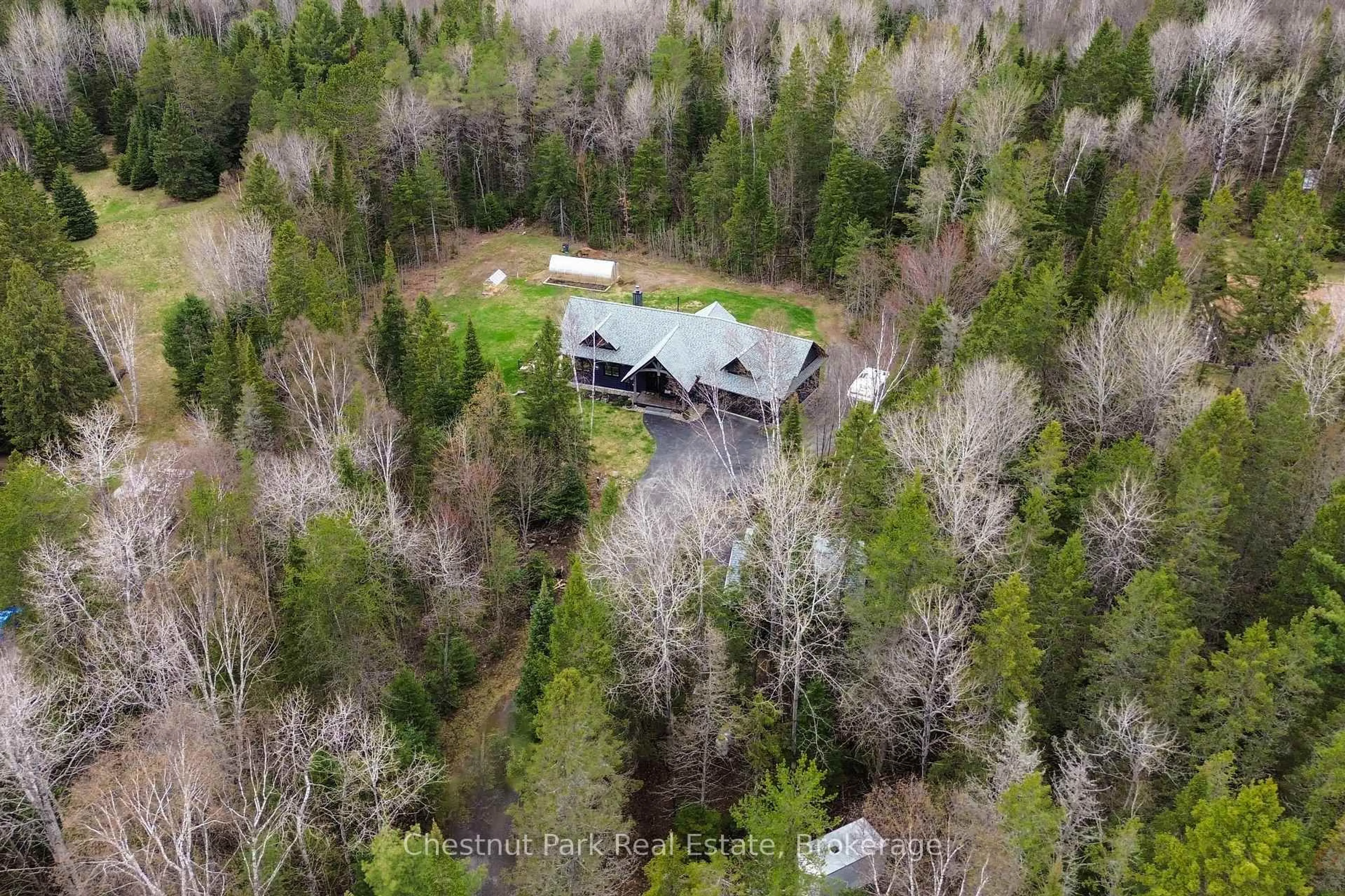 A pic from outside/outdoor area/front of a property/back of a property/a pic from drone, forest/trees view for 86 BOWYER Rd, Huntsville Ontario P1H 2J4