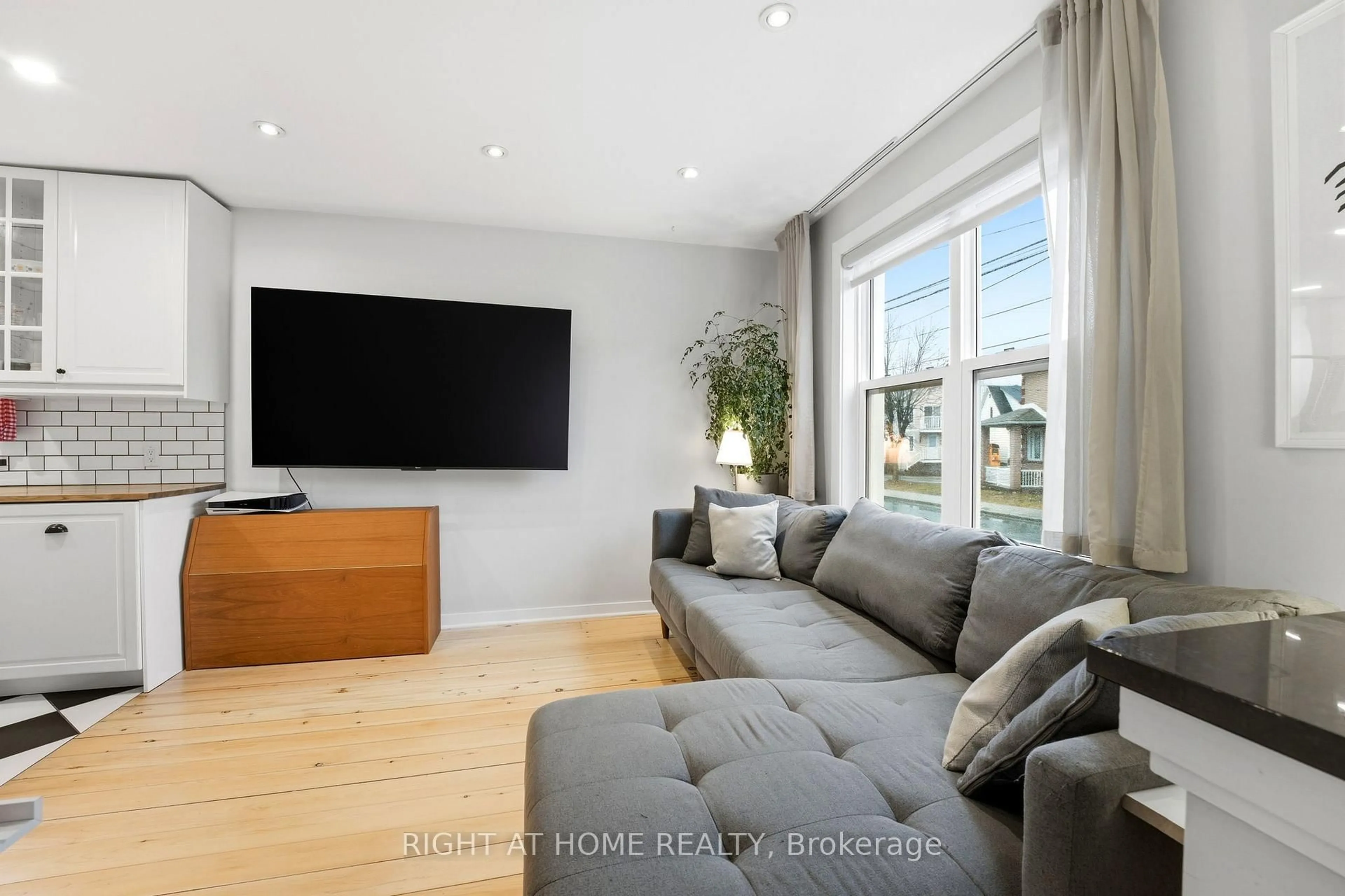 Living room with furniture, wood/laminate floor for 209 Marier Ave, Ottawa Ontario K1L 5R4