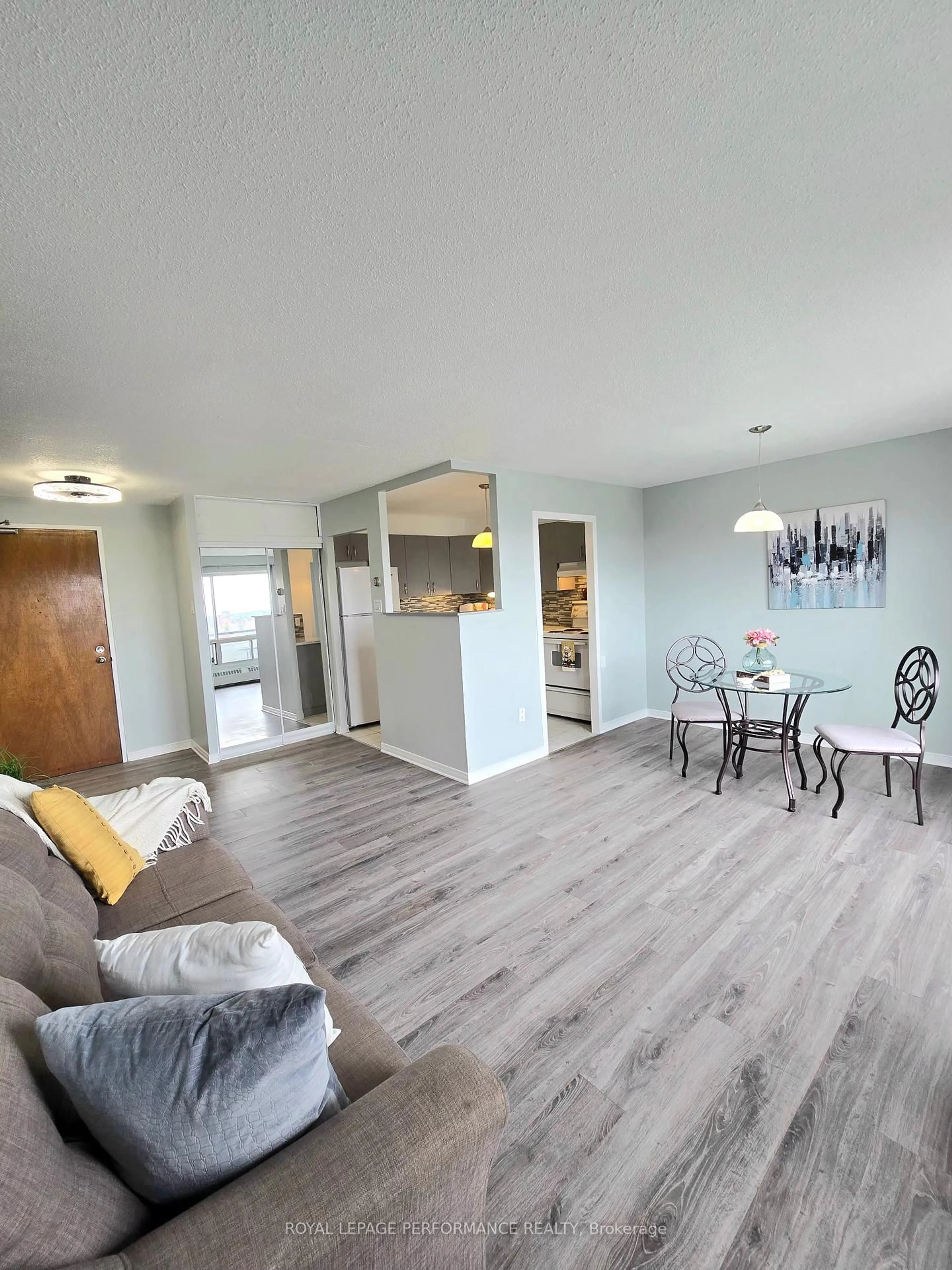 Living room with furniture, wood/laminate floor for 20 Chesterton Dr #1113, Ottawa Ontario K2E 6Z7