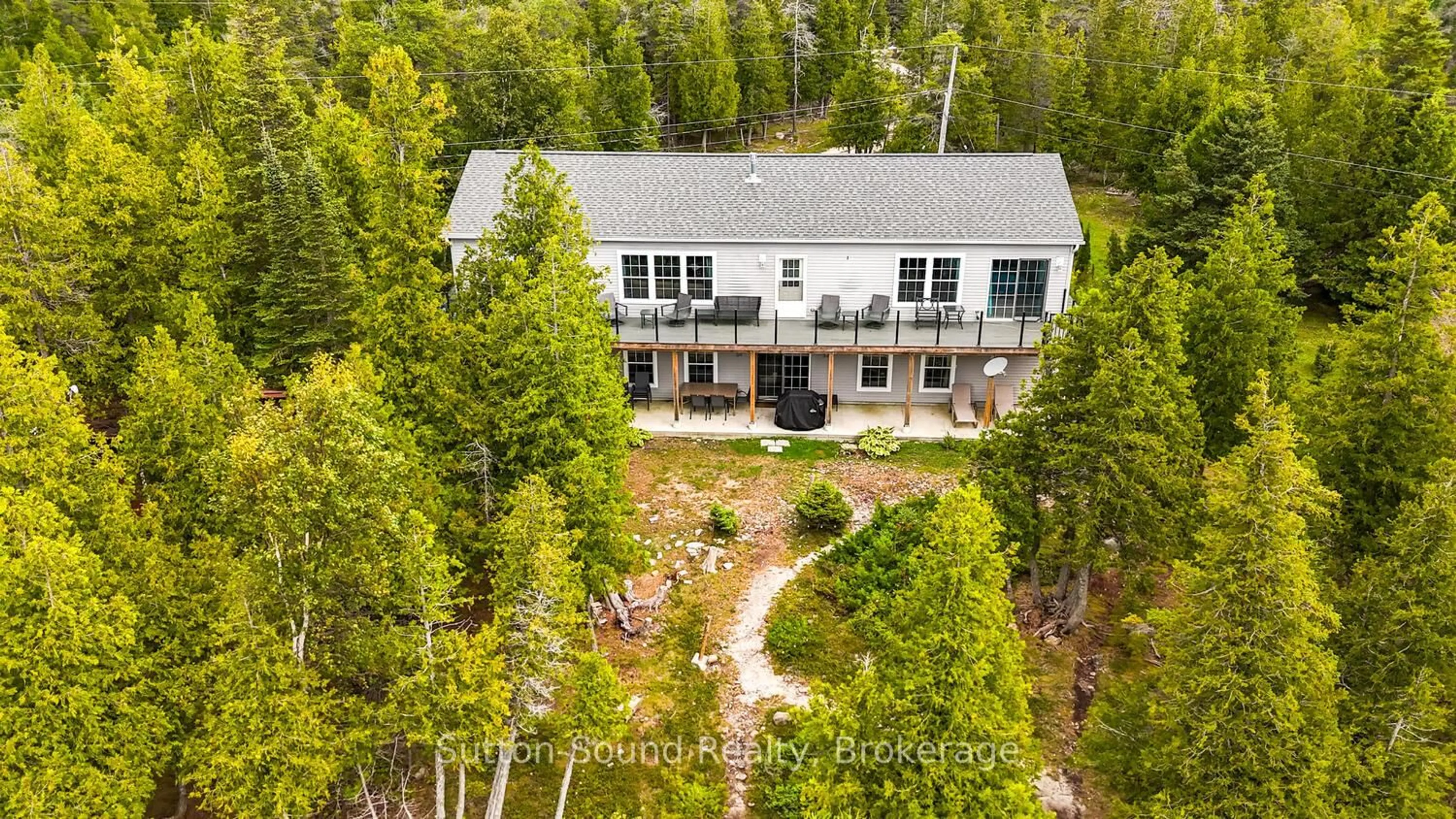 A pic from outside/outdoor area/front of a property/back of a property/a pic from drone, forest/trees view for 682 Dorcas Bay Rd, Northern Bruce Peninsula Ontario N0H 2R0