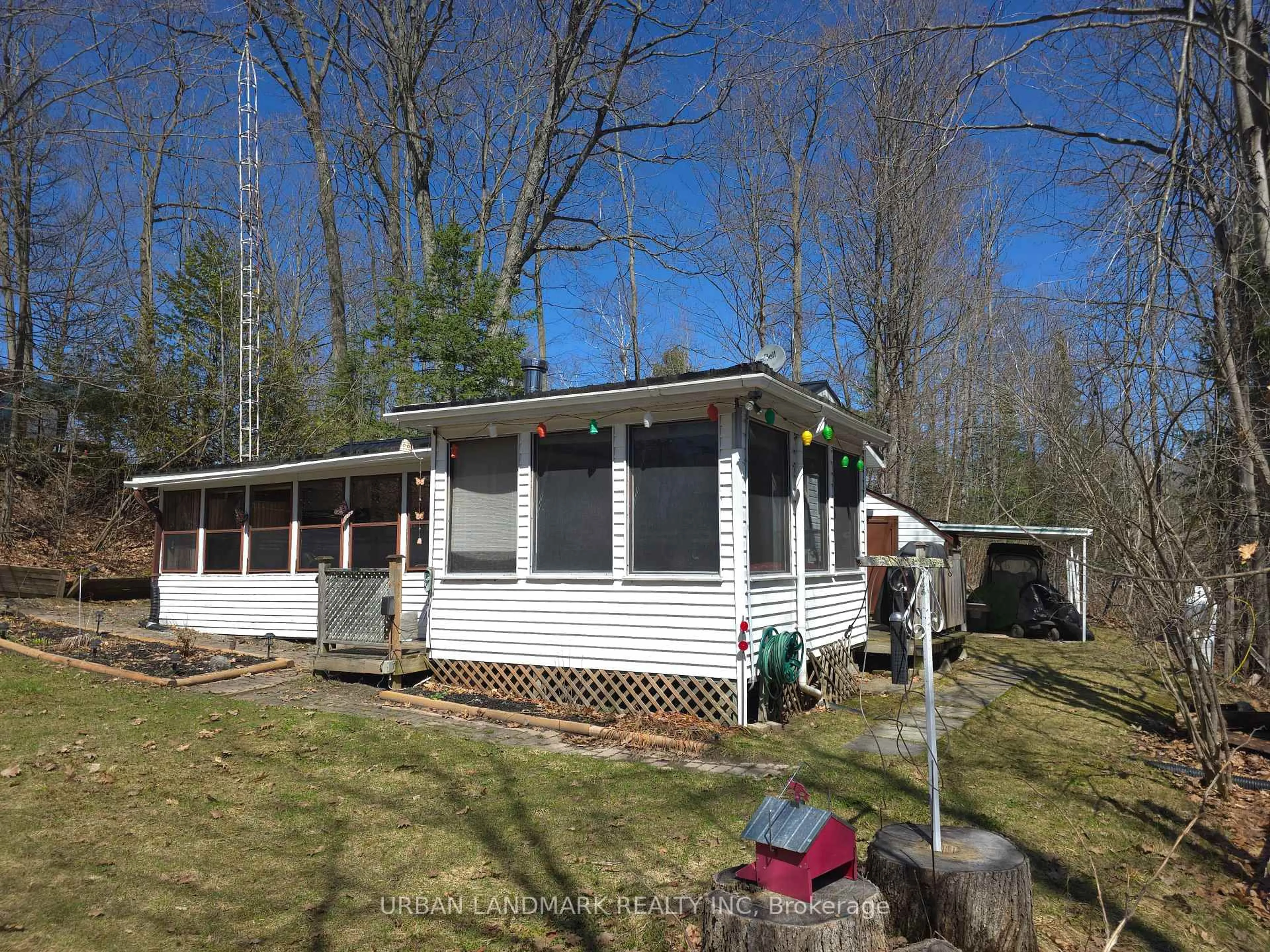 A pic from outside/outdoor area/front of a property/back of a property/a pic from drone, water/lake/river/ocean view for 302 Quin Mo Lac Rd #135A, Madoc Ontario K0K 2K0