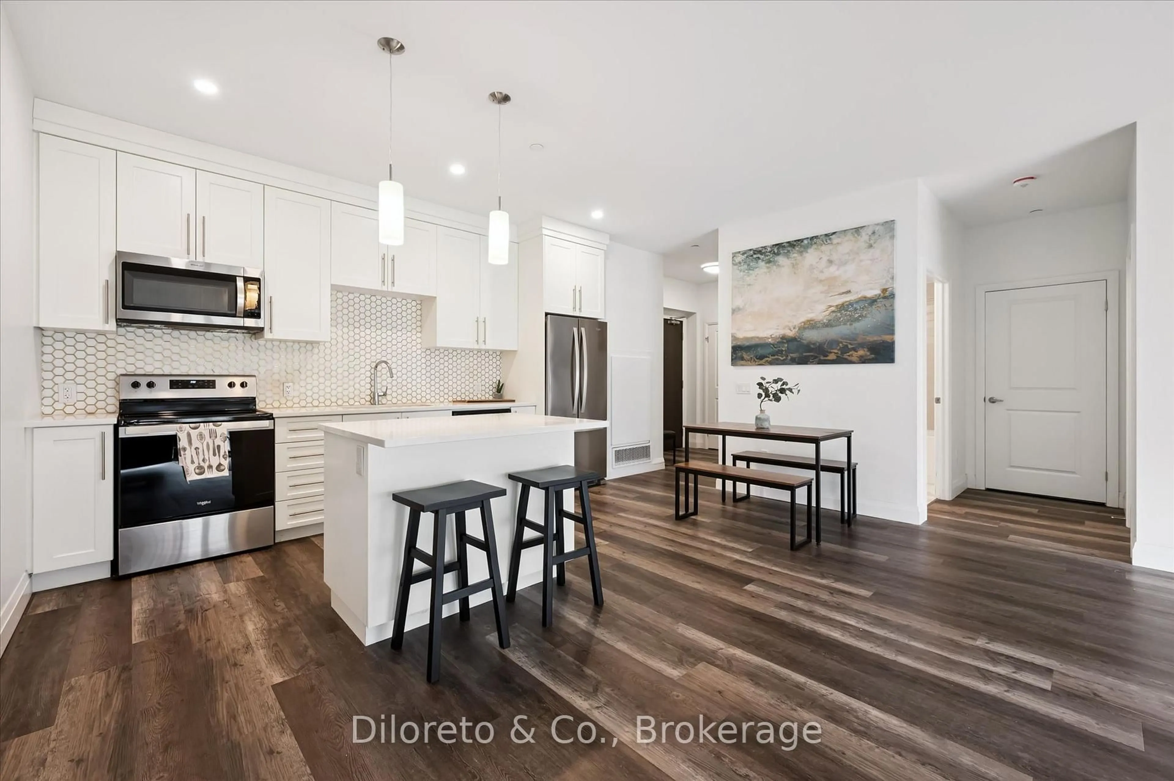Open concept kitchen, wood/laminate floor for 332 Gosling Gdns #110, Guelph Ontario N1L 0P8