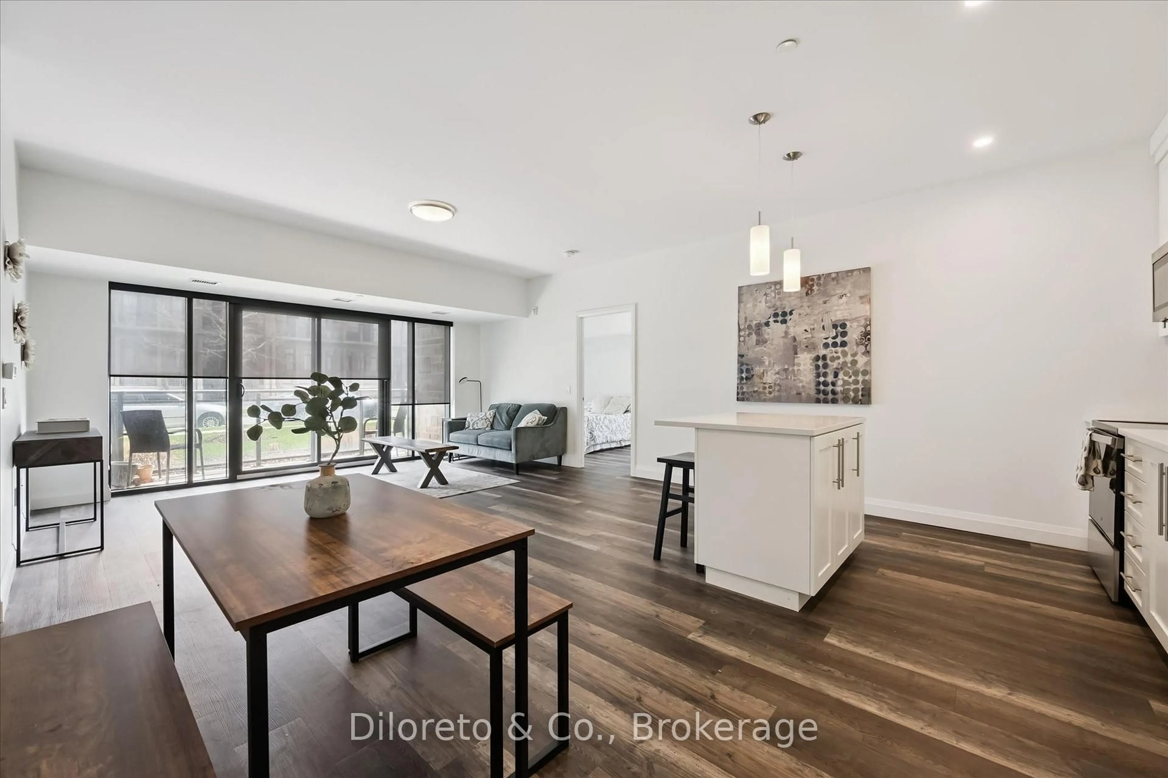 Open concept kitchen, wood/laminate floor for 332 Gosling Gdns #110, Guelph Ontario N1L 0P8