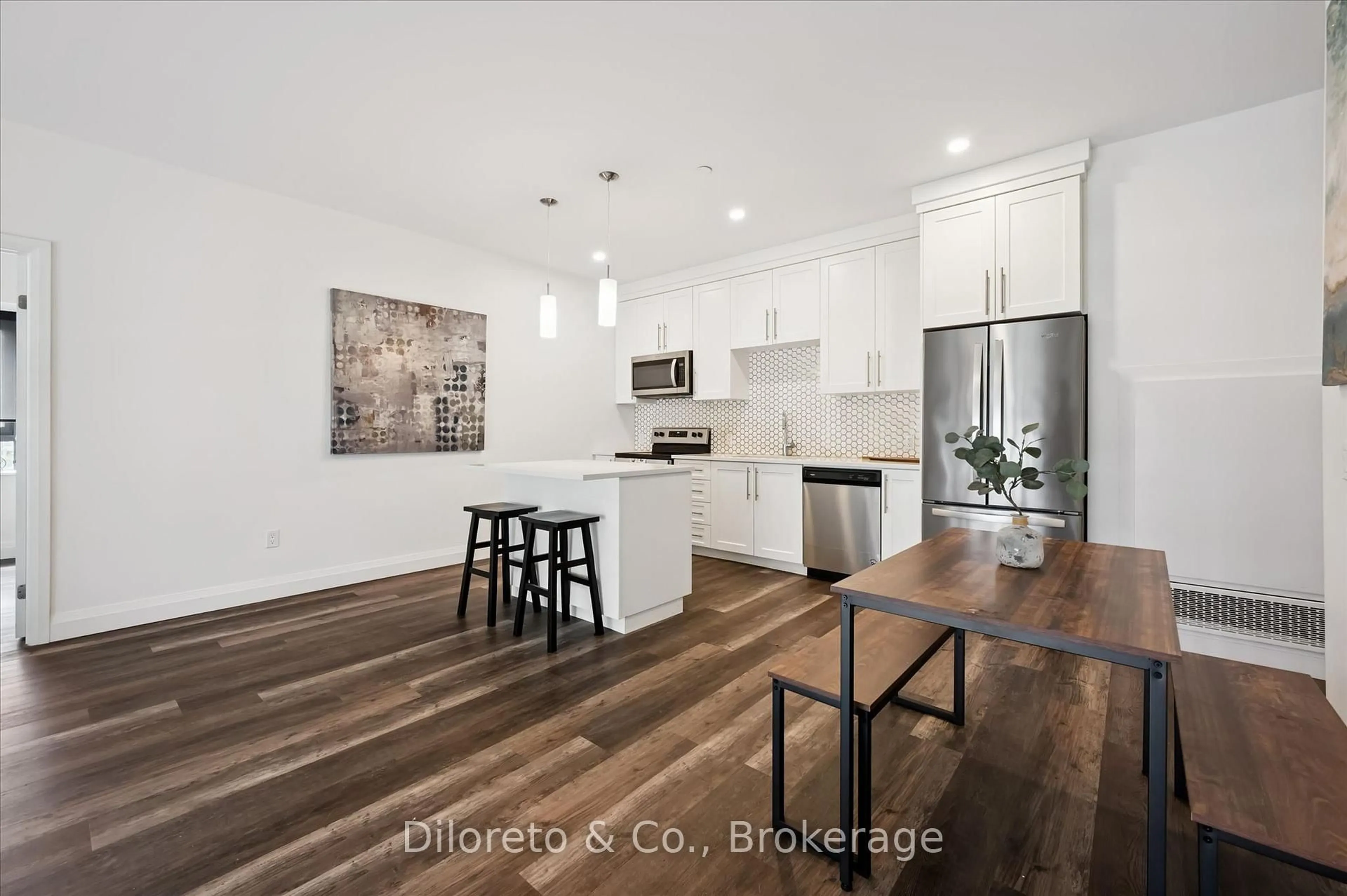 Open concept kitchen, wood/laminate floor for 332 Gosling Gdns #110, Guelph Ontario N1L 0P8