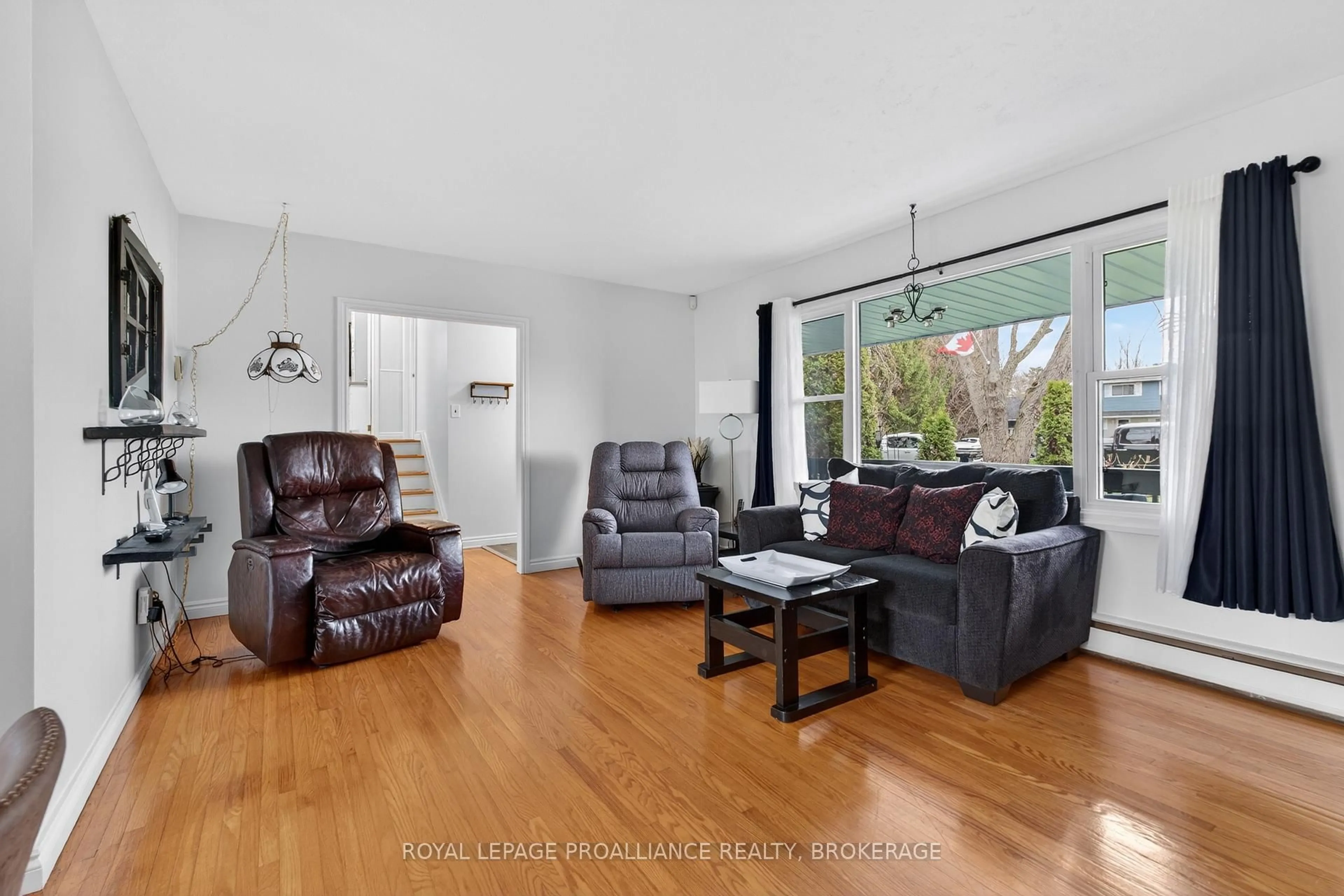 Living room with furniture, wood/laminate floor for 104 Park Dr, Bath Ontario K0H 1G0