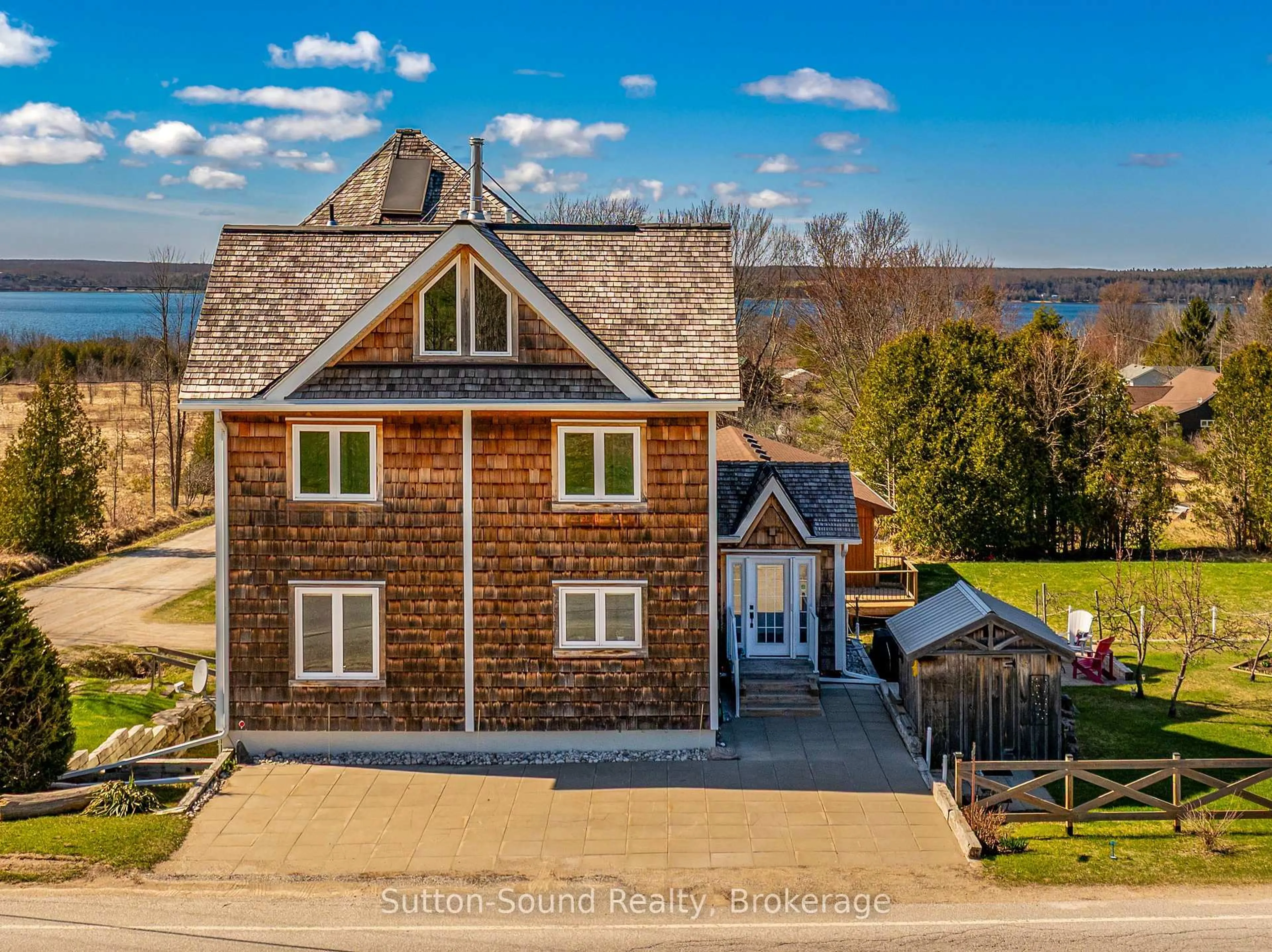 A pic from outside/outdoor area/front of a property/back of a property/a pic from drone, water/lake/river/ocean view for 501483 Grey Road 1 Rd, Georgian Bluffs Ontario N0H 2T0