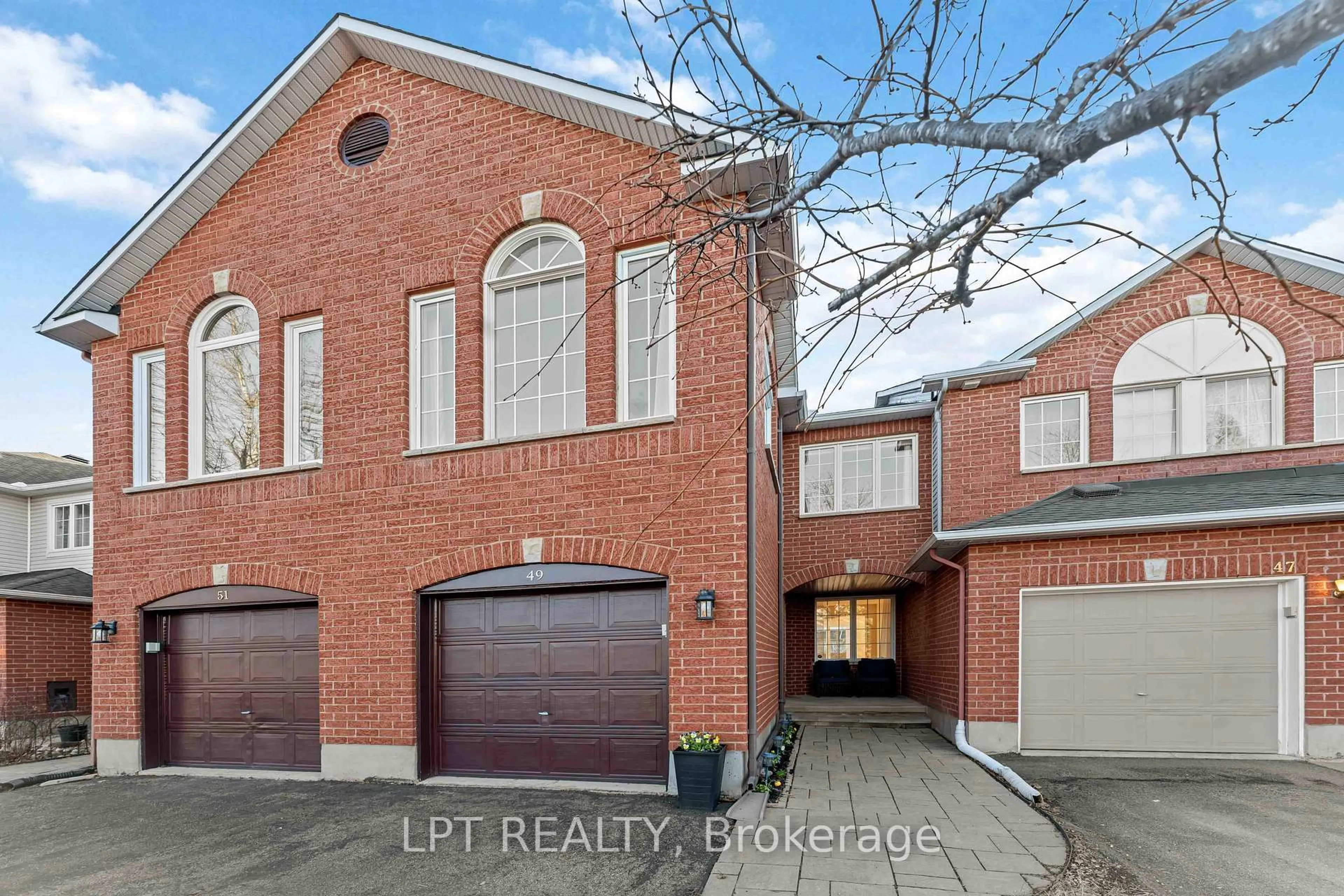 Home with brick exterior material, street for 49 Pennard Way, Ottawa Ontario K1T 4C1