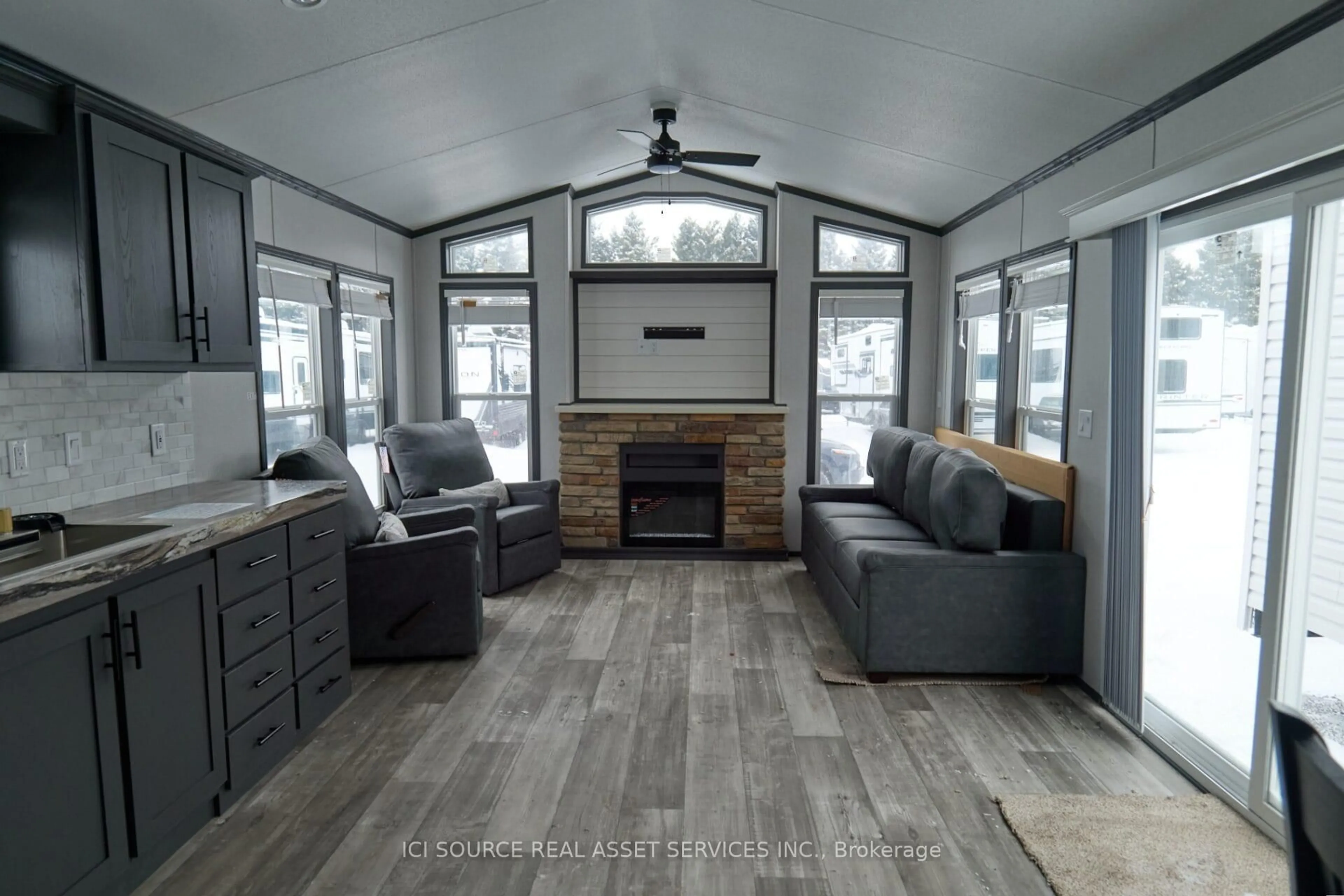 Living room with furniture, wood/laminate floor for 1082 Shamrock Marina Rd #REDWD, Gravenhurst Ontario P0E 1N0