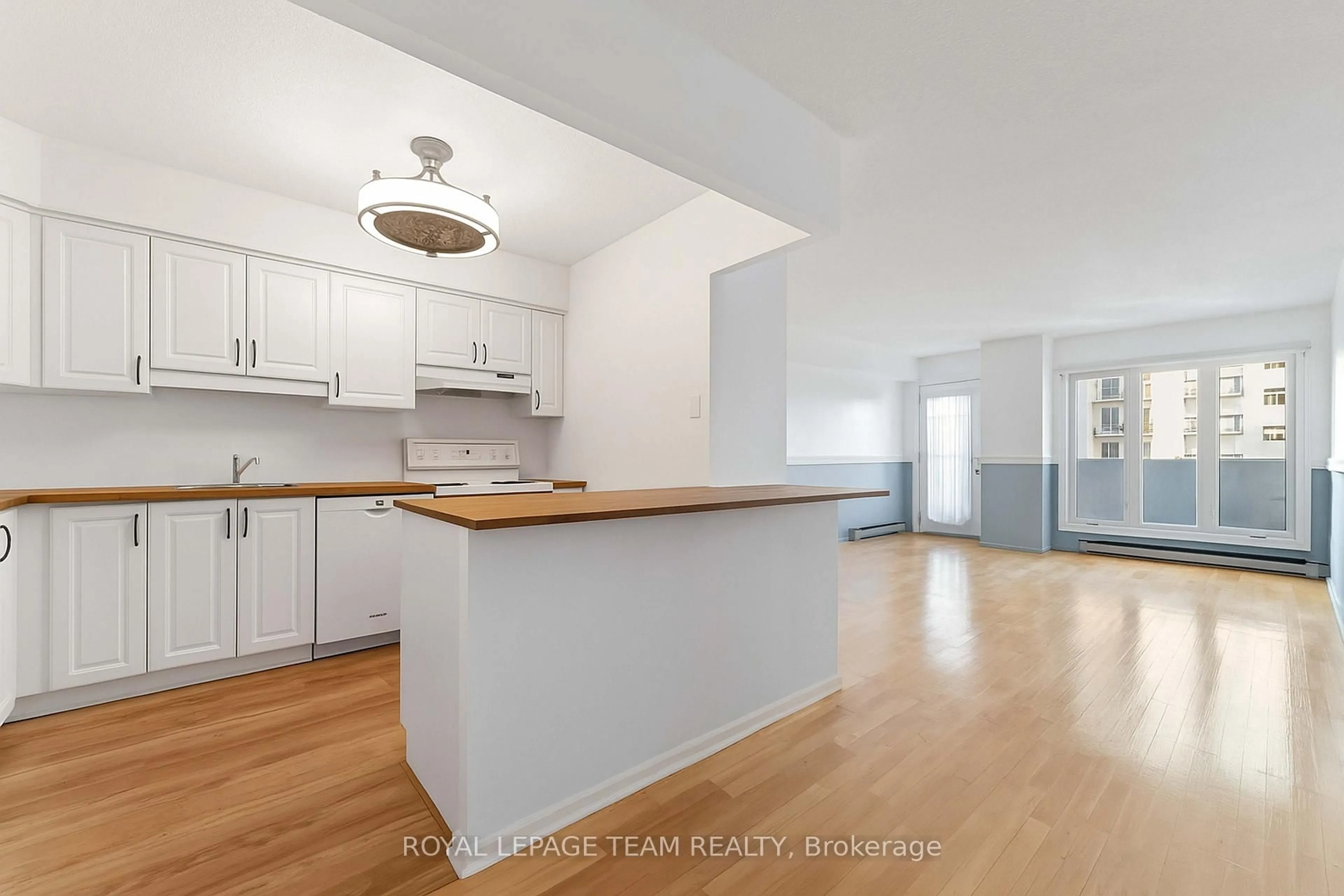 Open concept kitchen, wood/laminate floor for 158C McArthur Ave #606, Ottawa Ontario K1L 8E7