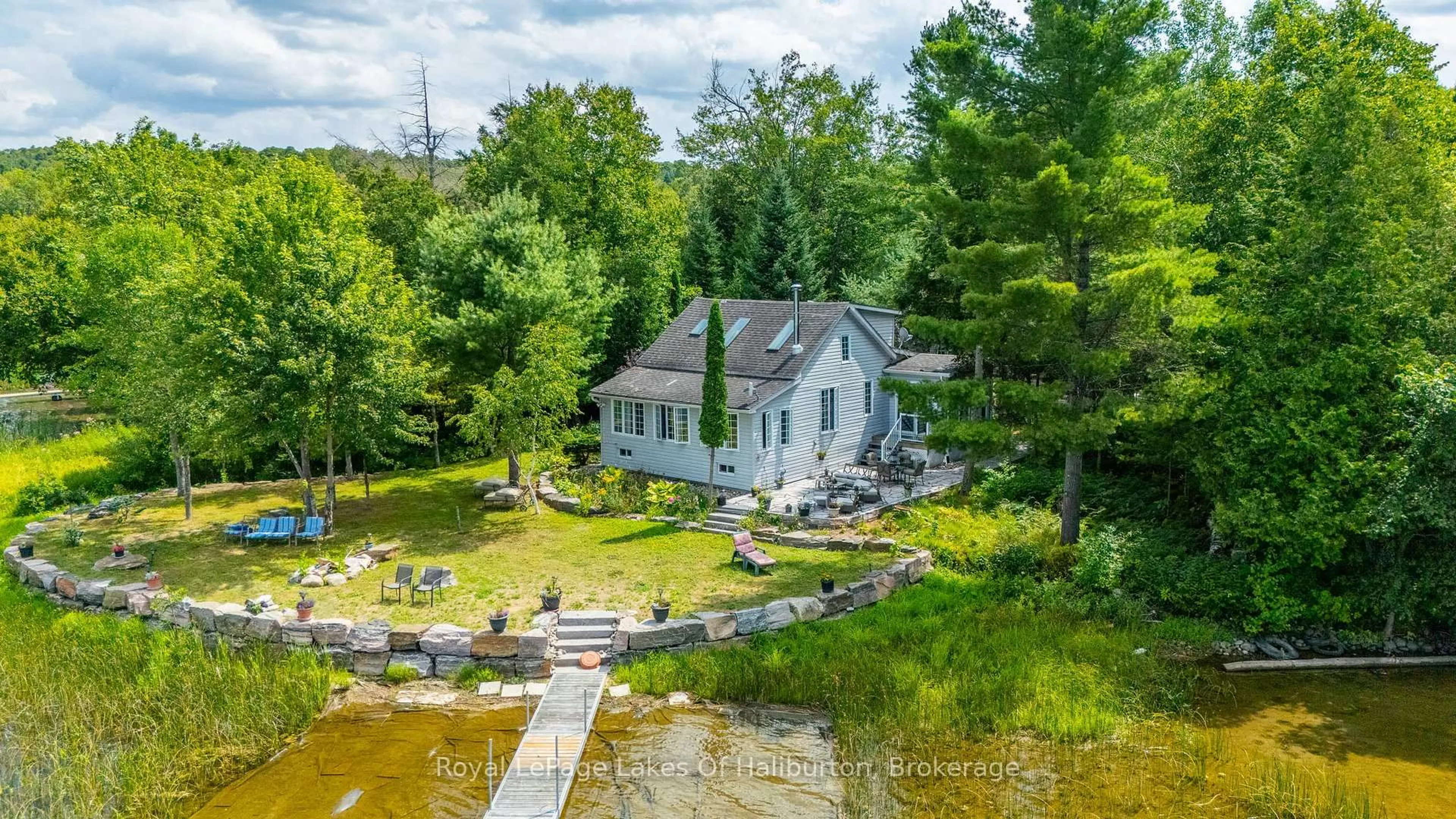 A pic from outside/outdoor area/front of a property/back of a property/a pic from drone, water/lake/river/ocean view for 1049 Ninatigo Lane, Algonquin Highlands Ontario K0M 1S0