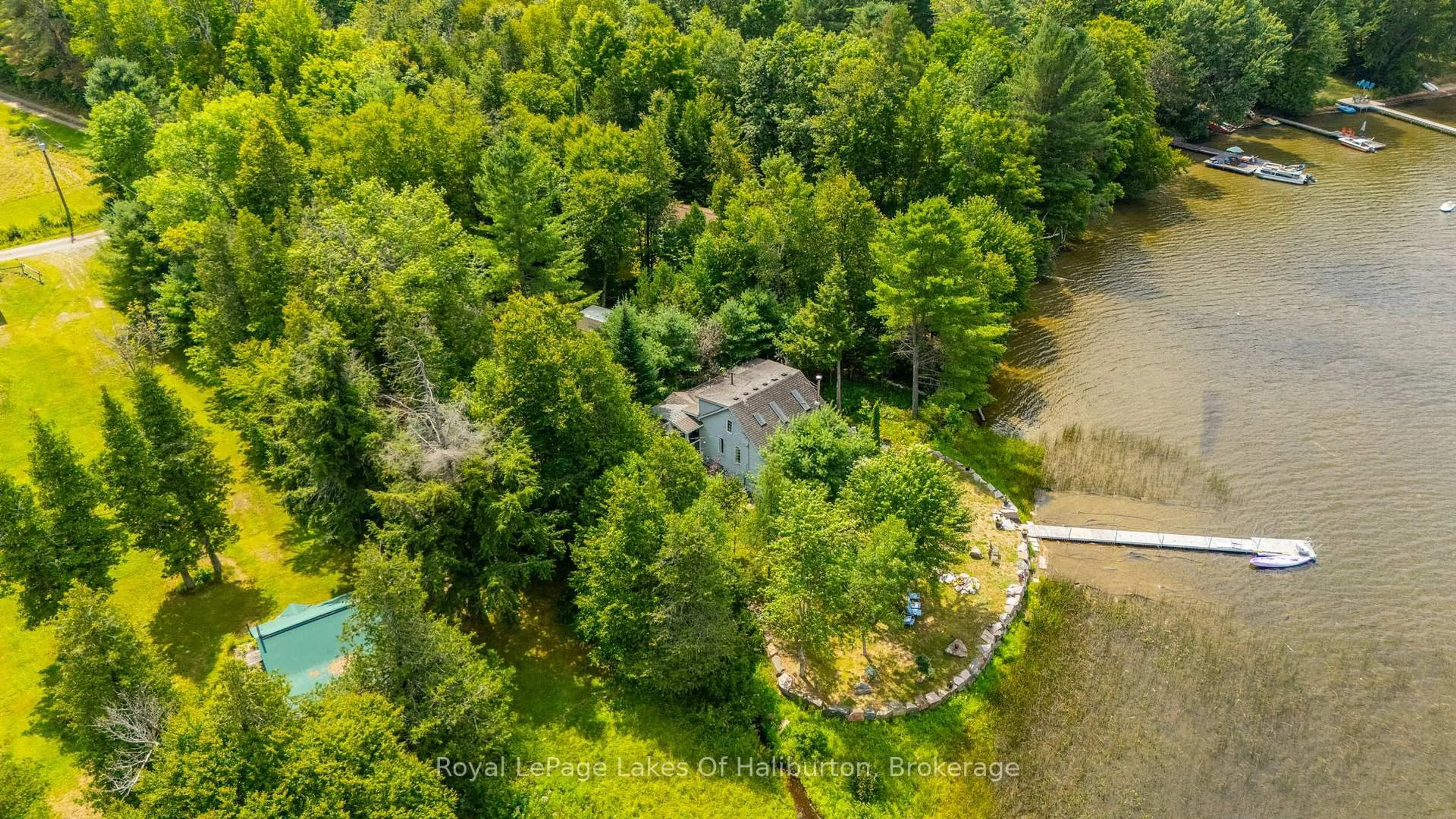 A pic from outside/outdoor area/front of a property/back of a property/a pic from drone, water/lake/river/ocean view for 1049 Ninatigo Lane, Algonquin Highlands Ontario K0M 1S0