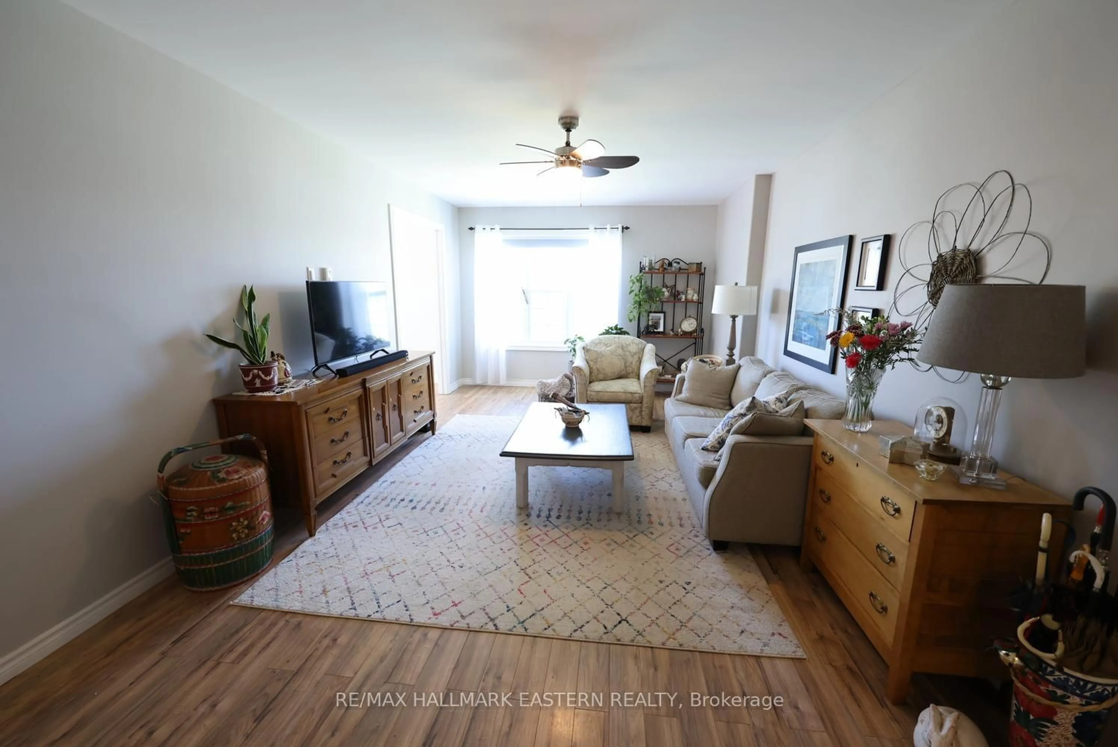 Living room with furniture, wood/laminate floor for 122 Homewood Ave #6, Trent Hills Ontario K0L 1Y0