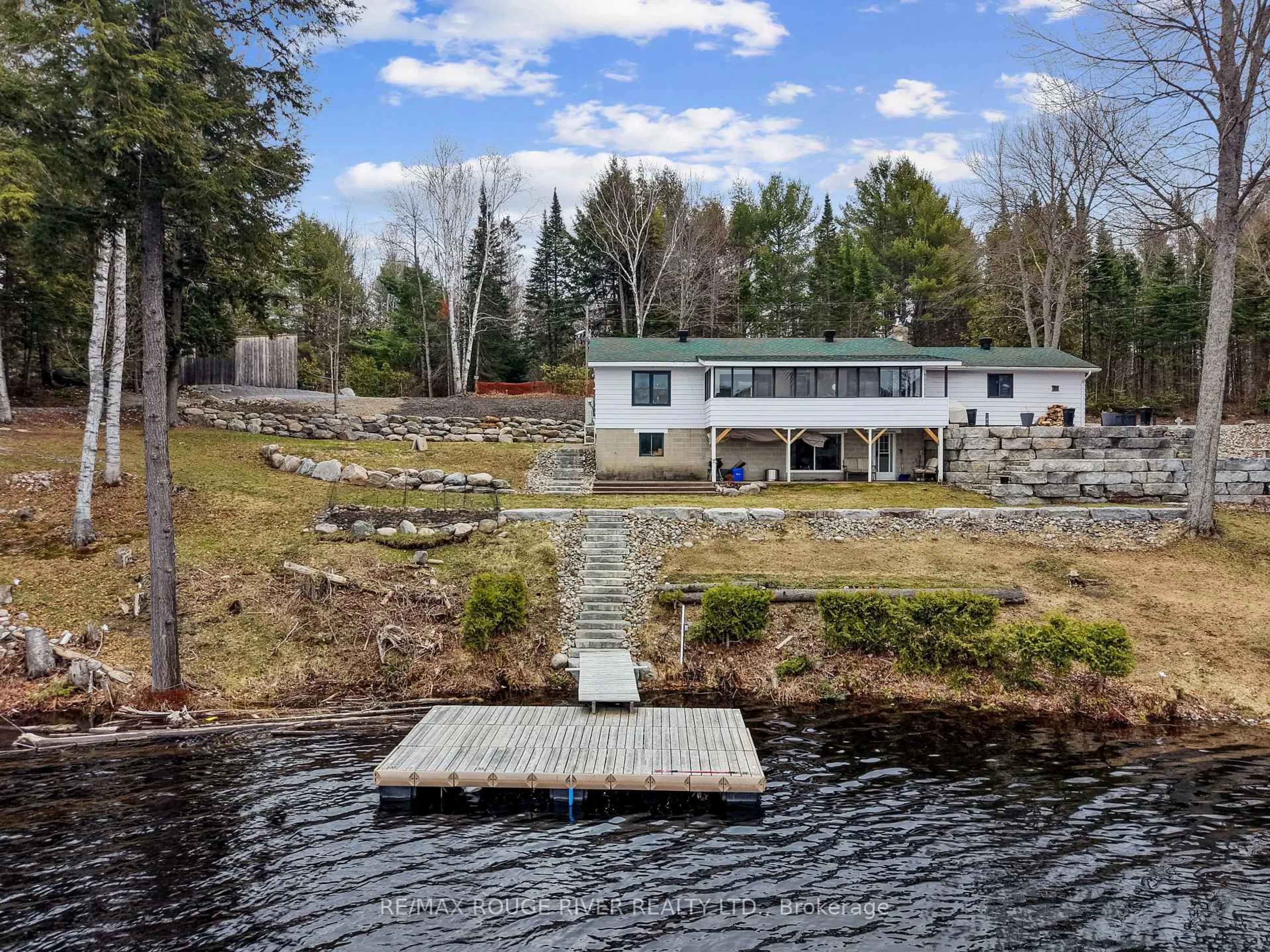A pic from outside/outdoor area/front of a property/back of a property/a pic from drone, water/lake/river/ocean view for 1087 Lagoon Rd, Highlands East Ontario K0L 1C0