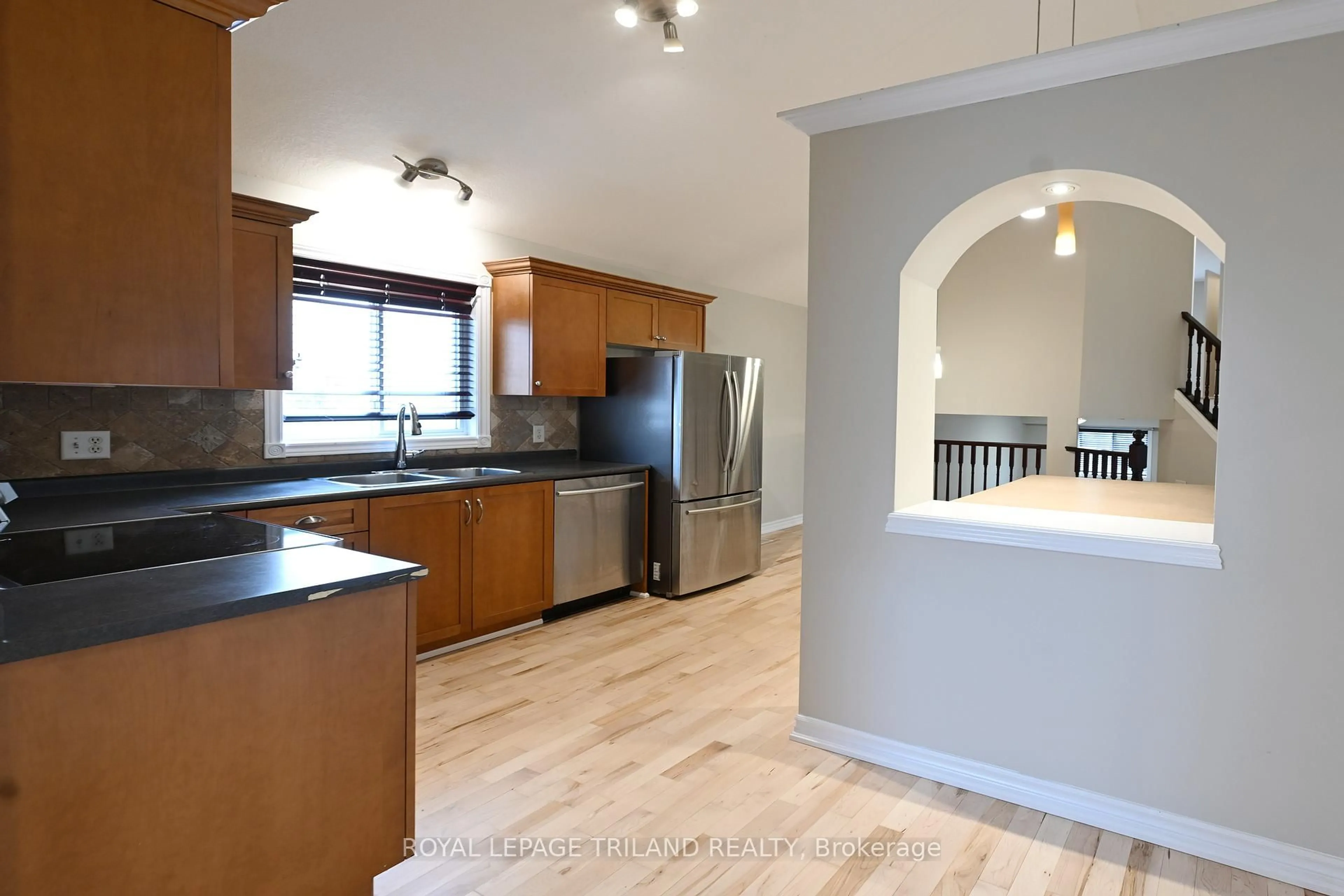 Open concept kitchen, wood/laminate floor for 803 Sandcherry St, London North Ontario N6H 5T9