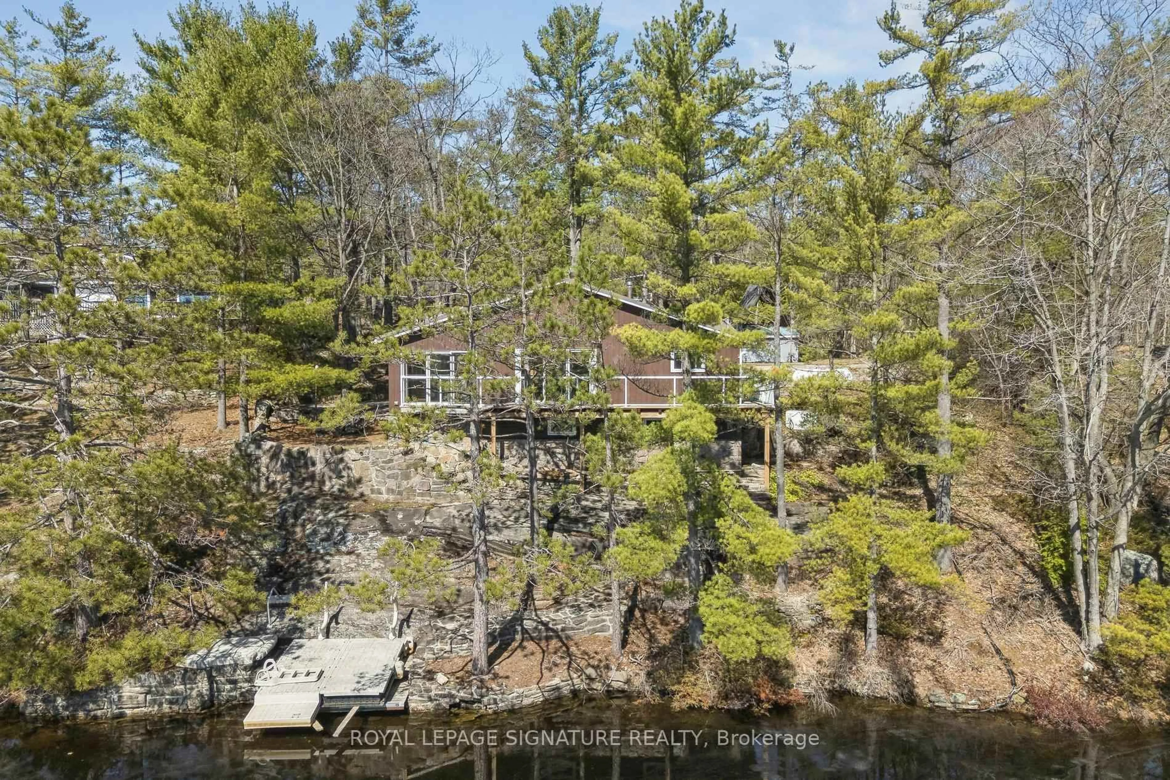 A pic from outside/outdoor area/front of a property/back of a property/a pic from drone, water/lake/river/ocean view for 18 Loon Lake Rd, Gravenhurst Ontario P1P 1R2