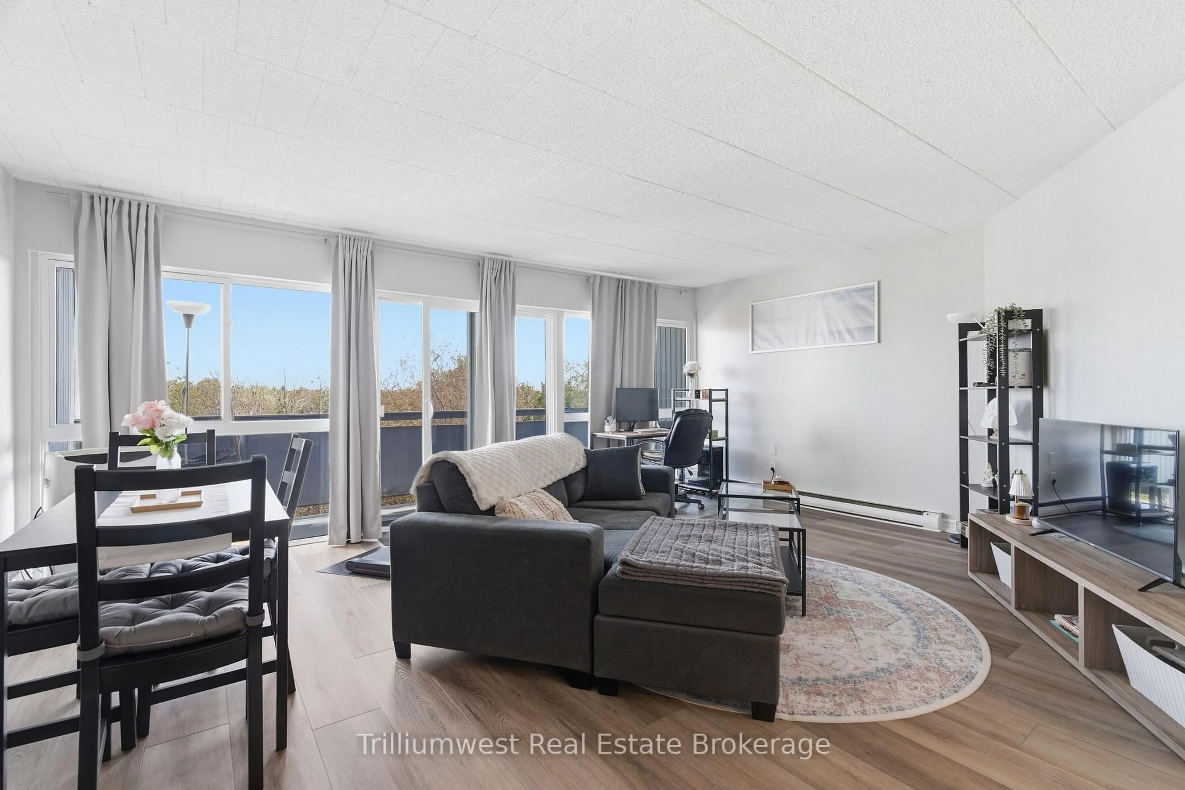 Living room with furniture, wood/laminate floor for 91 Conroy Cres, Guelph Ontario N1G 2V5