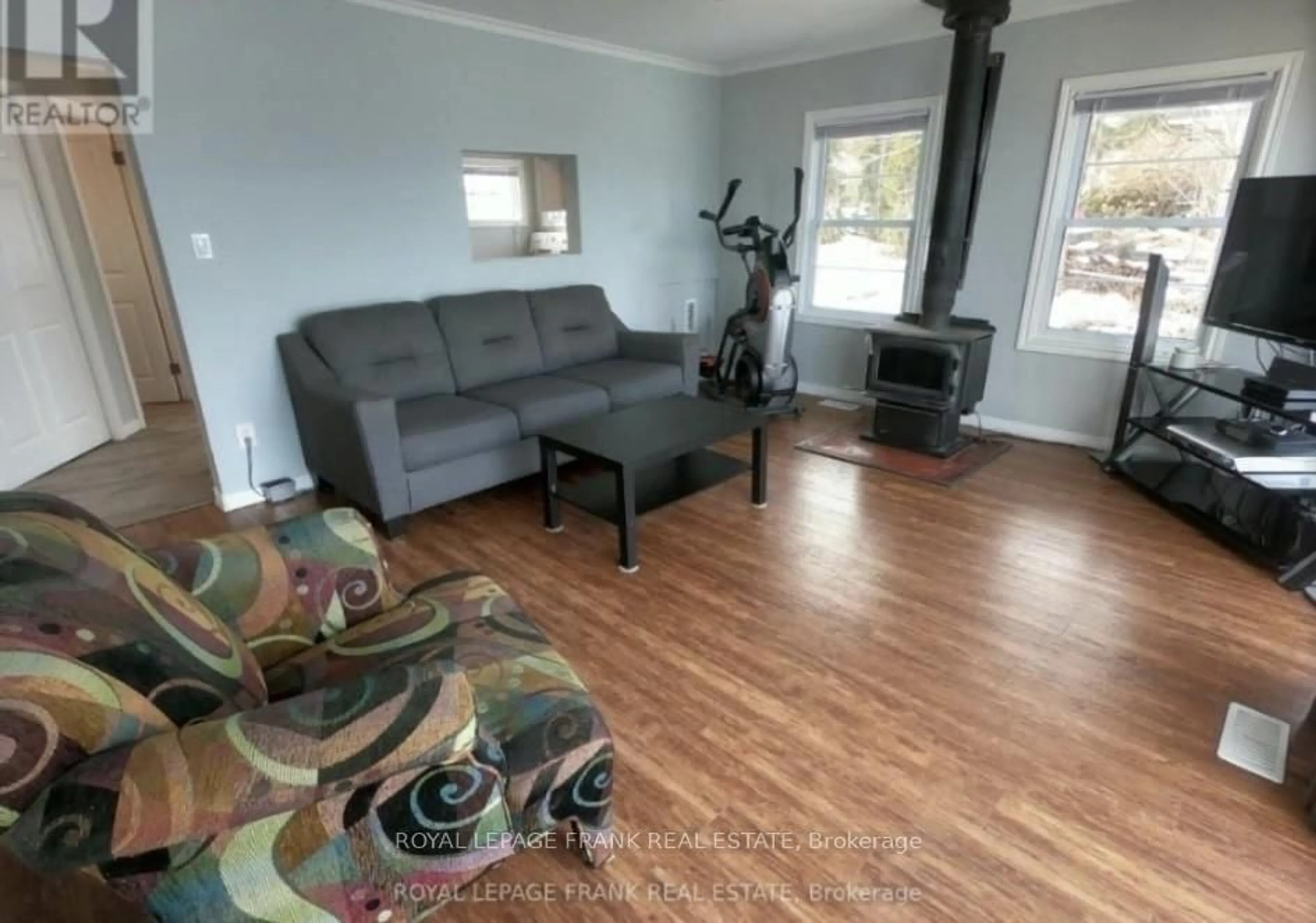 Living room with furniture, wood/laminate floor for 6108 Curtis Point Rd #17, Alnwick/Haldimand Ontario K0K 2X0