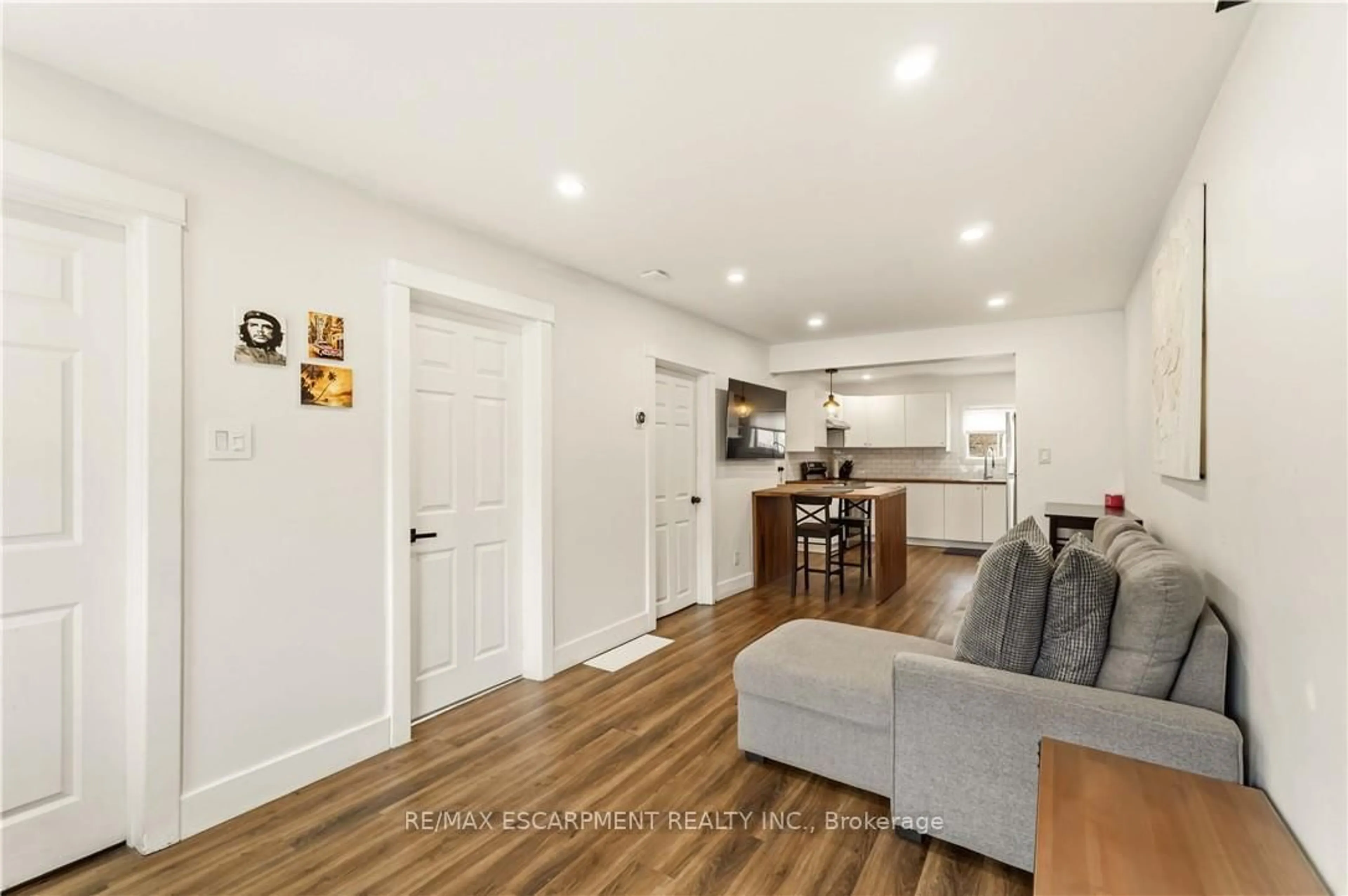 Open concept kitchen, wood/laminate floor for 27 Edinburgh Ave, Hamilton Ontario L8H 2C4