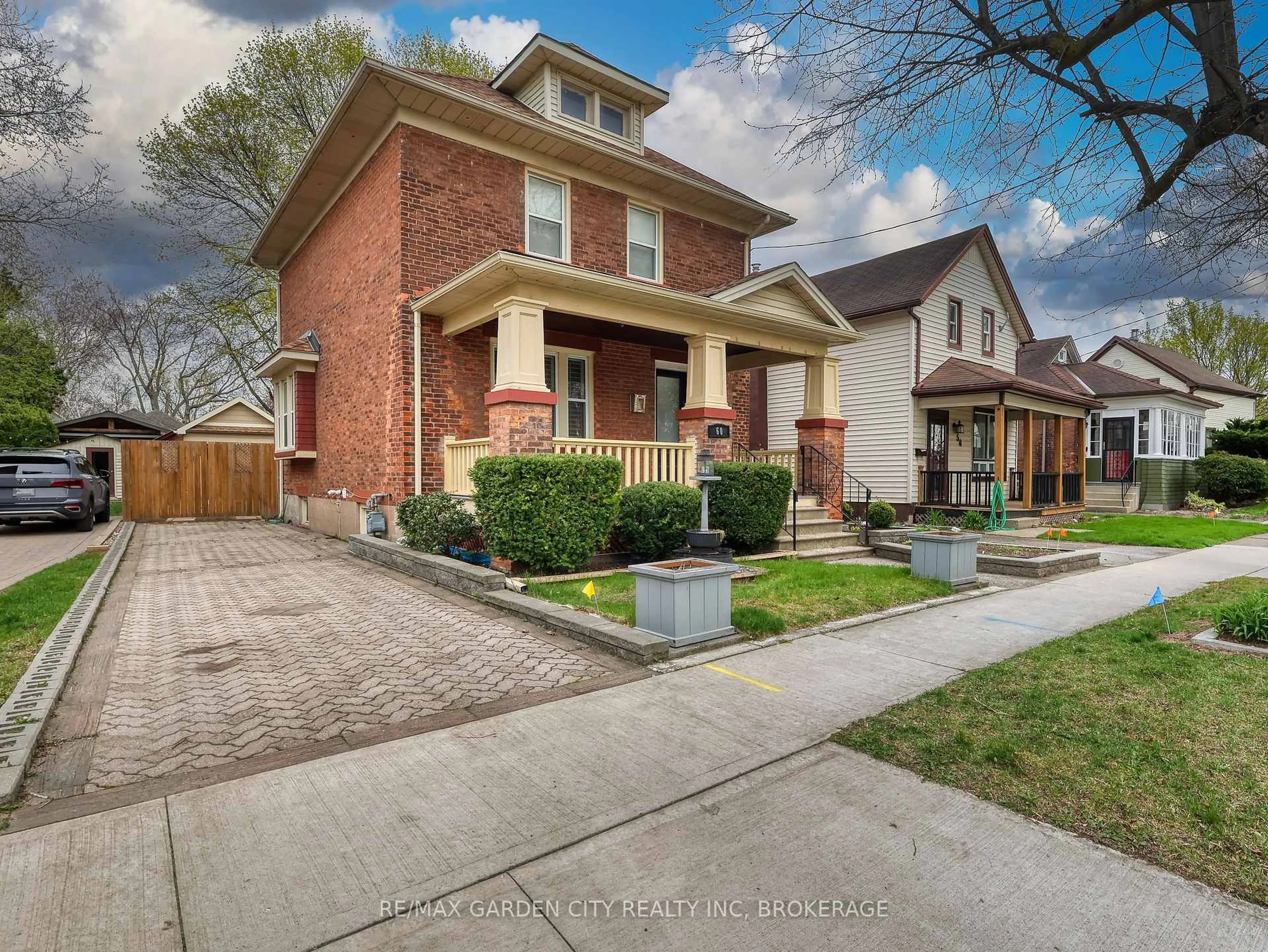 Home with brick exterior material, street for 60 Woodland Ave, St. Catharines Ontario L2R 5A3