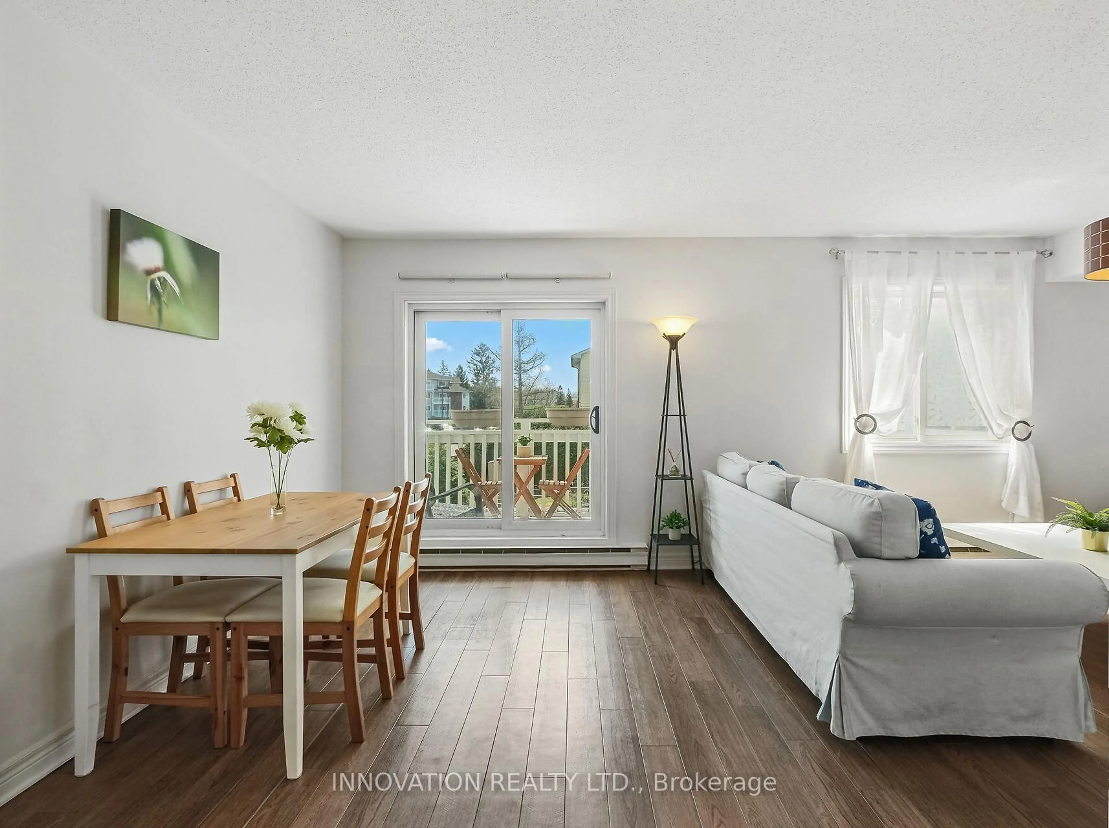 Living room with furniture, wood/laminate floor for 270 Lorry Greenberg Dr #110, Ottawa Ontario K1T 3K2