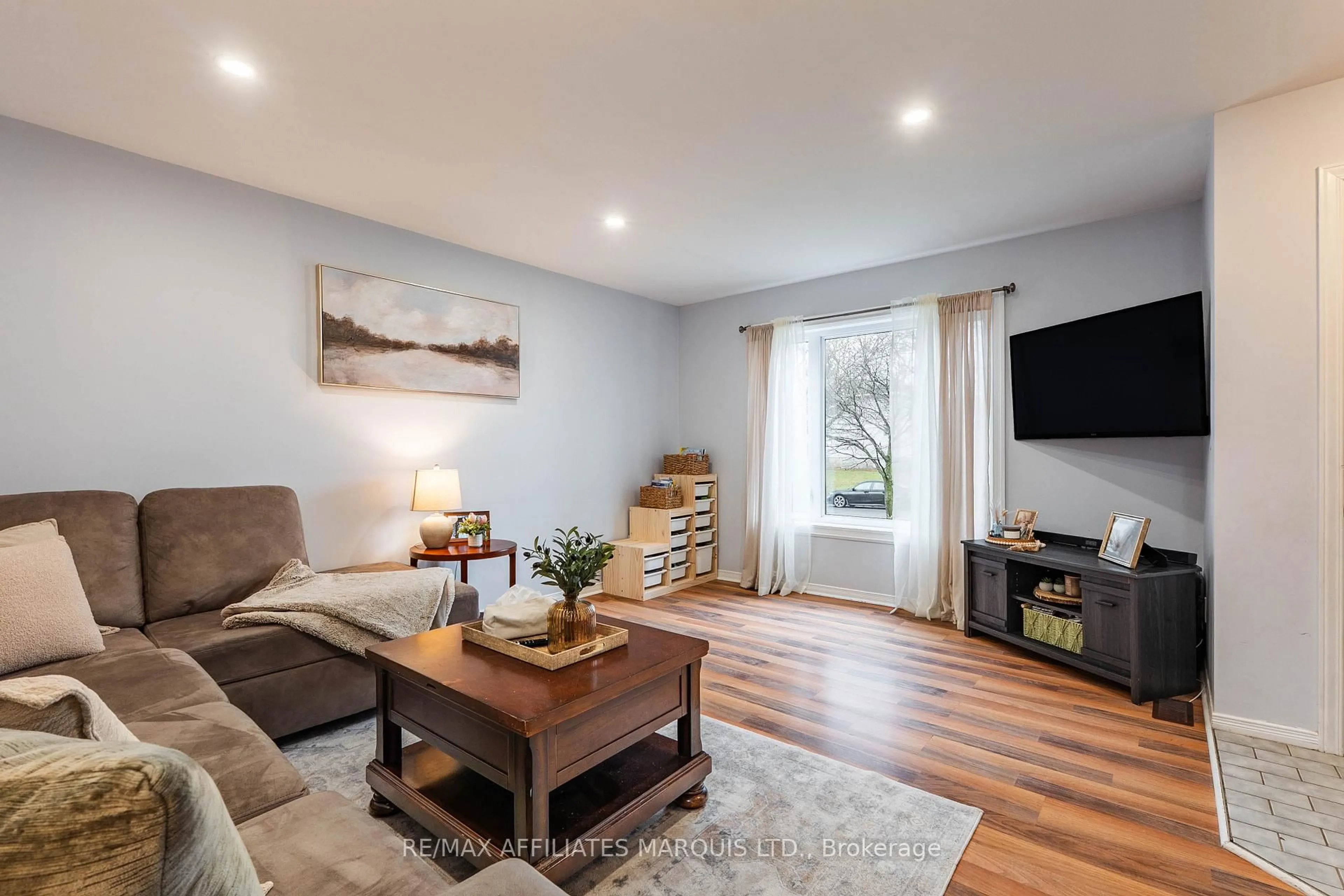 Living room with furniture, wood/laminate floor for 2333 Emily Cres, Cornwall Ontario K6H 7H5