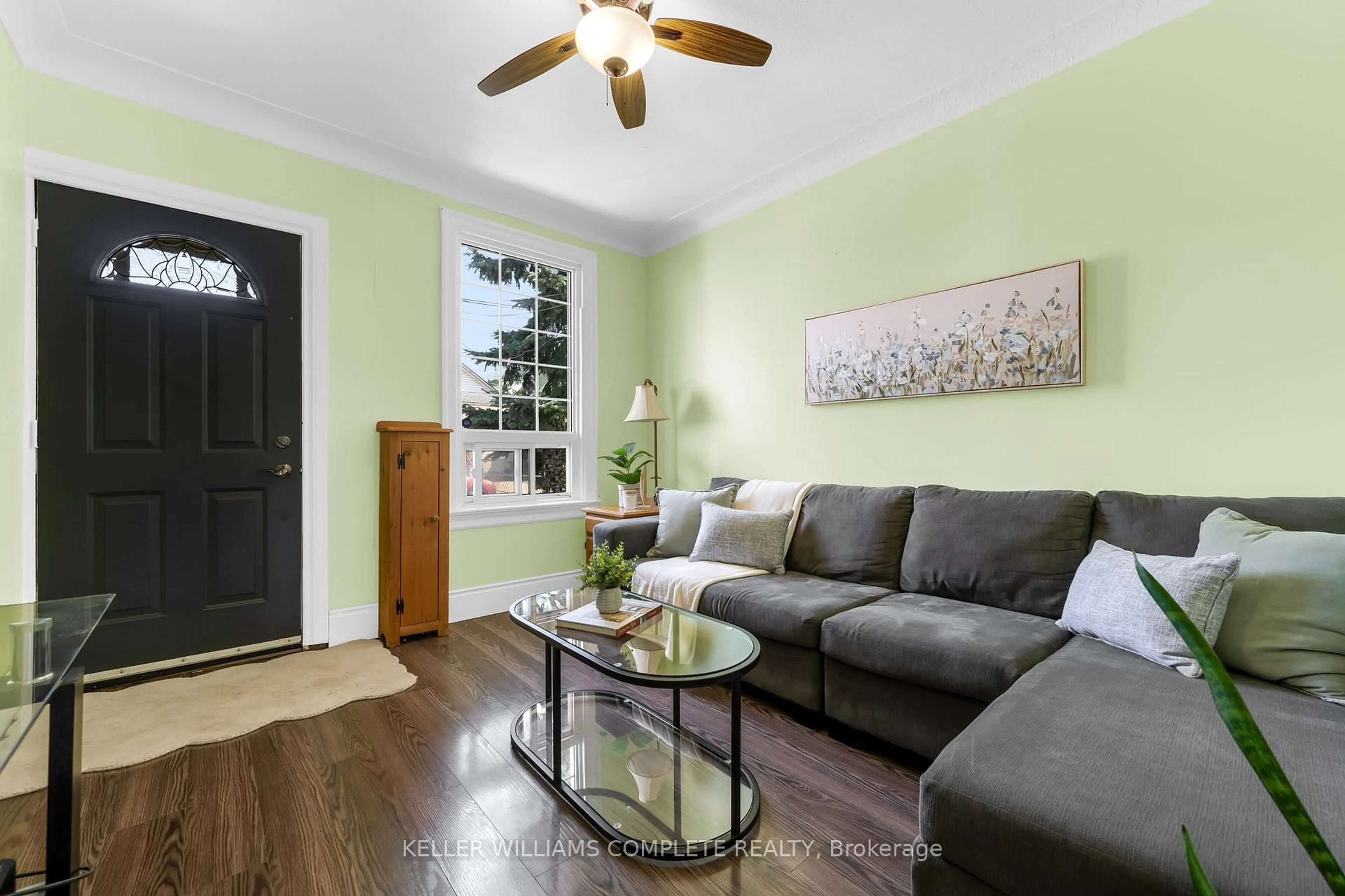 Living room with furniture, wood/laminate floor for 73 Norman St, Hamilton Ontario L8H 4J4