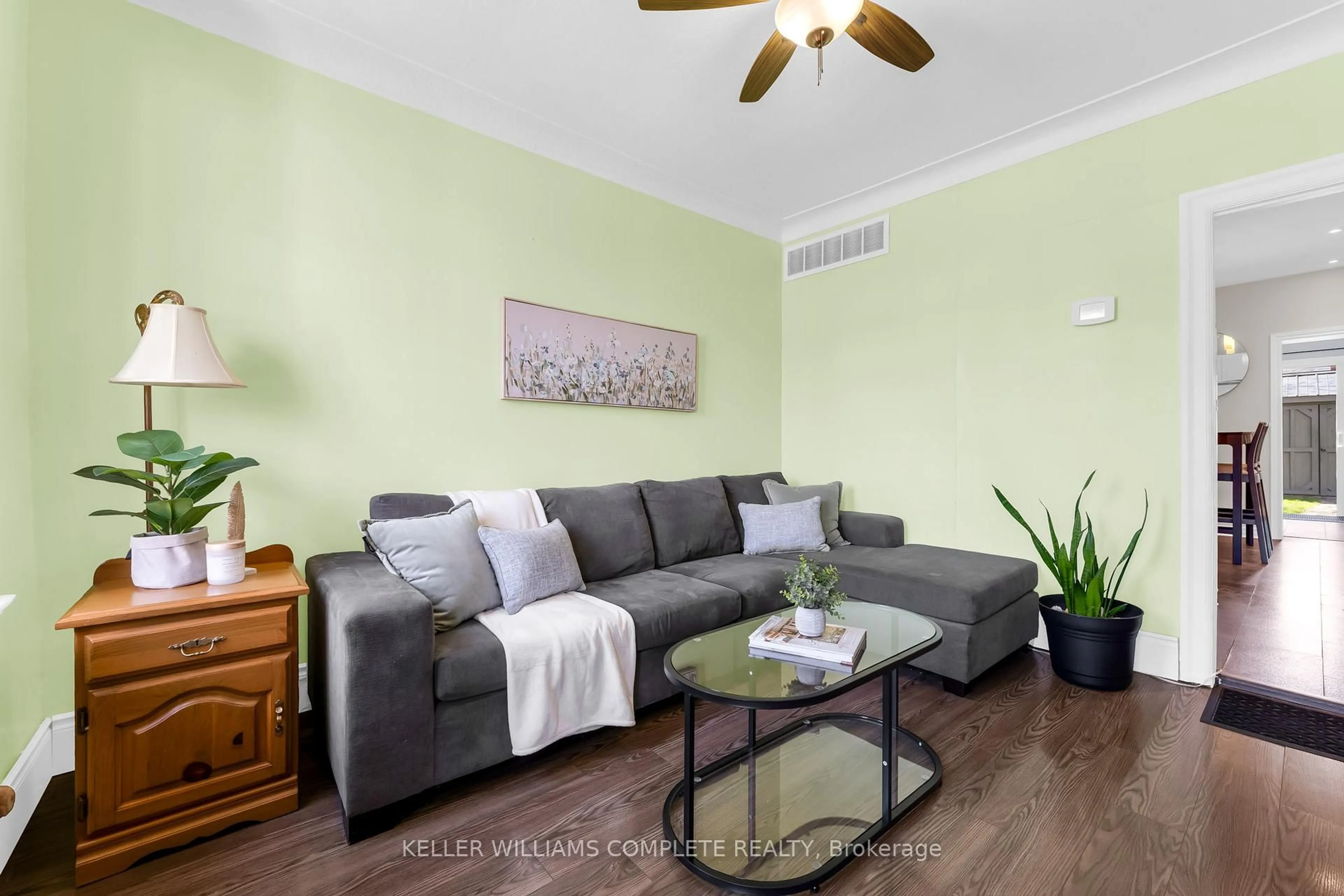 Living room with furniture, wood/laminate floor for 73 Norman St, Hamilton Ontario L8H 4J4