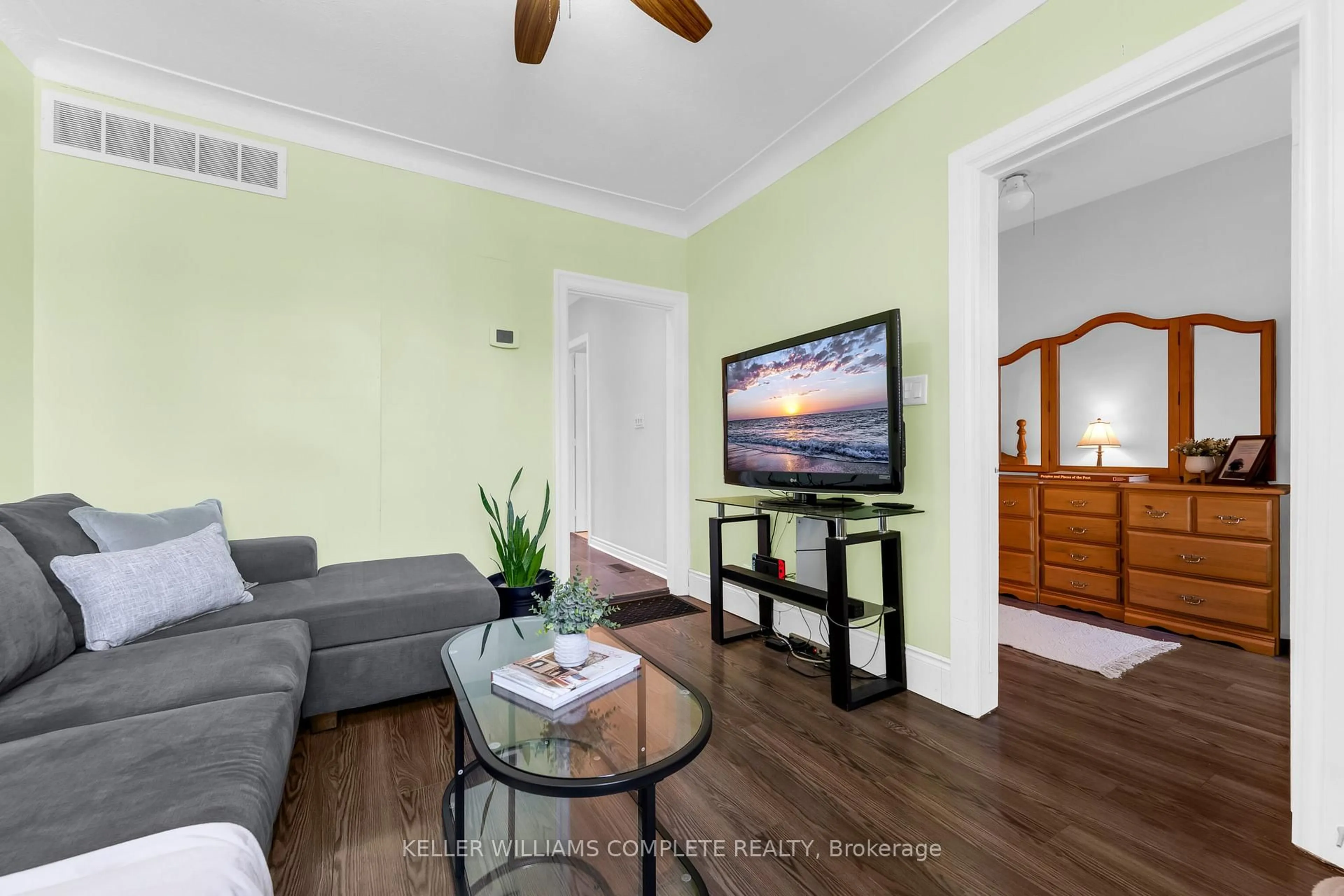 Living room with furniture, wood/laminate floor for 73 Norman St, Hamilton Ontario L8H 4J4