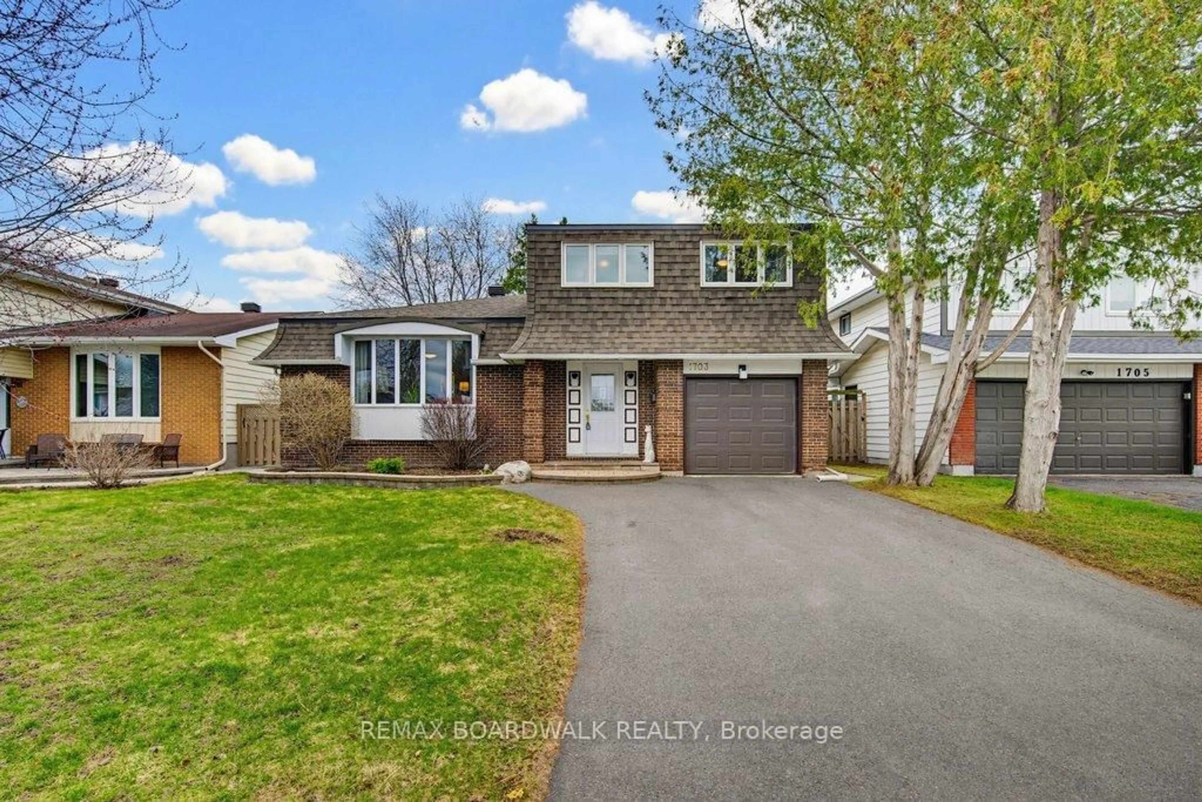 Home with vinyl exterior material, street for 1703 Fieldstone Cres, Ottawa Ontario K1C 1R6