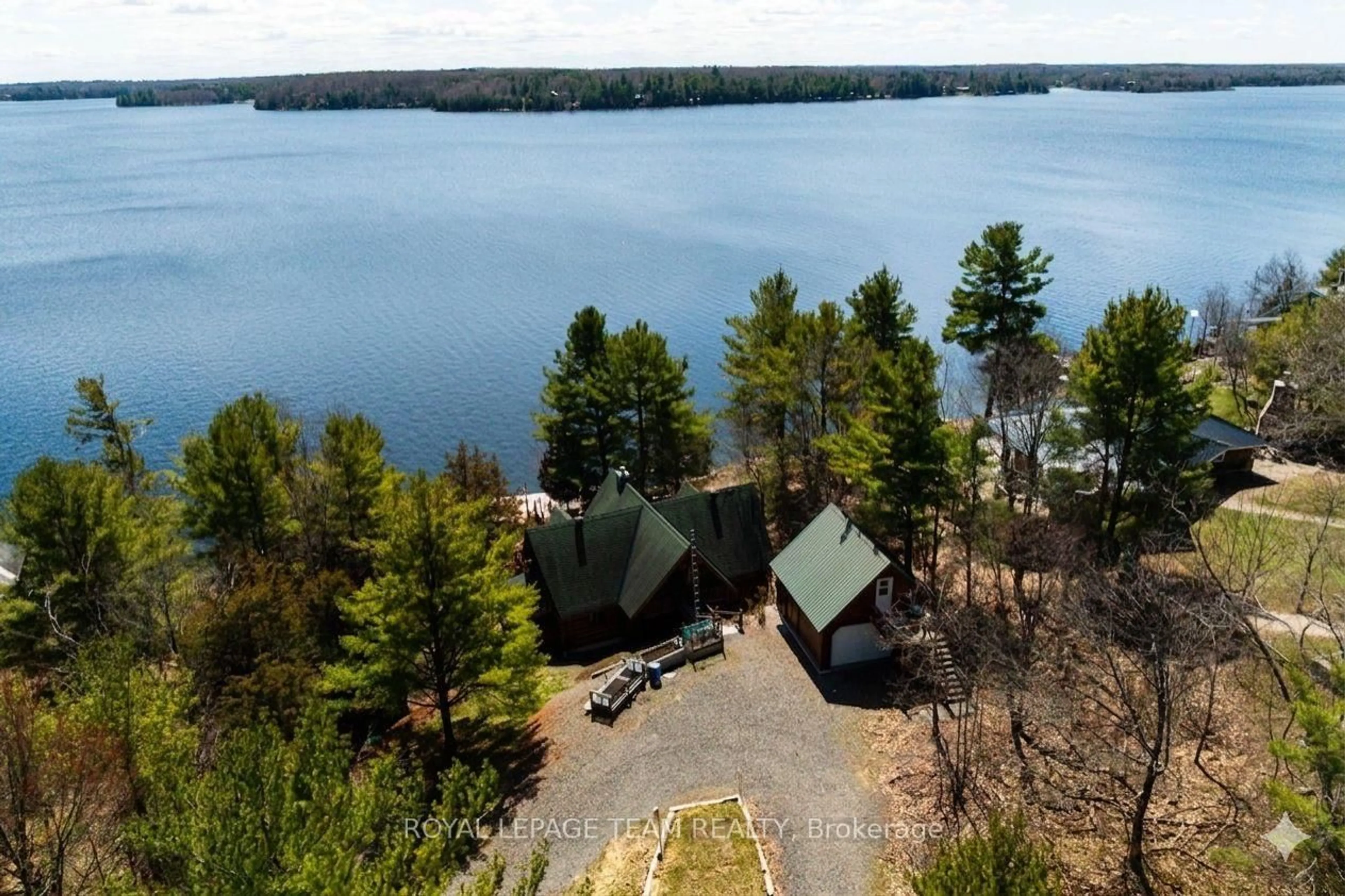 A pic from outside/outdoor area/front of a property/back of a property/a pic from drone, water/lake/river/ocean view for 781 Big Rideau North Shore Rd, Perth Ontario K7H 3C5