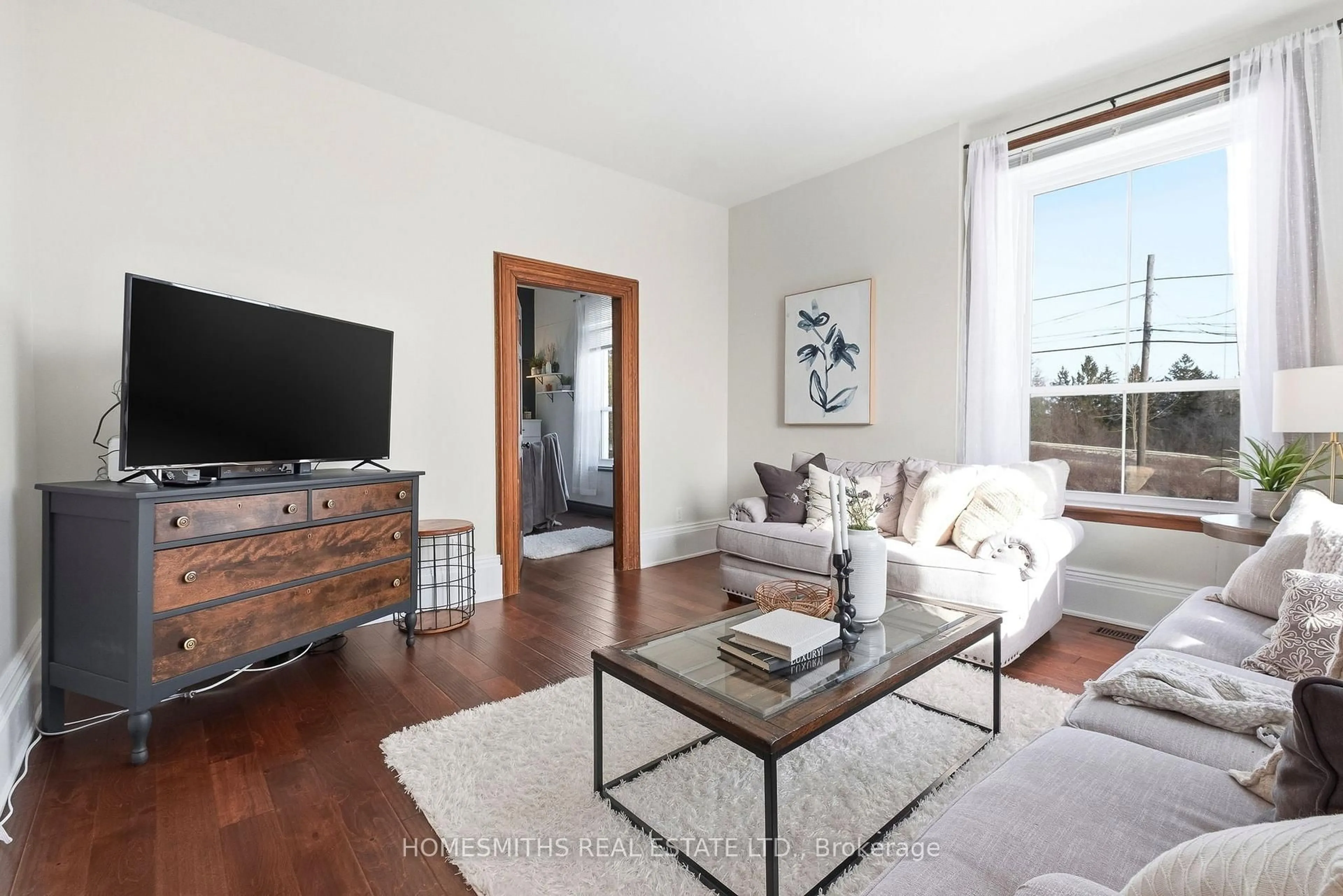 Living room with furniture, wood/laminate floor for 8766 Danforth Rd, Hamilton Township Ontario K9A 0X6