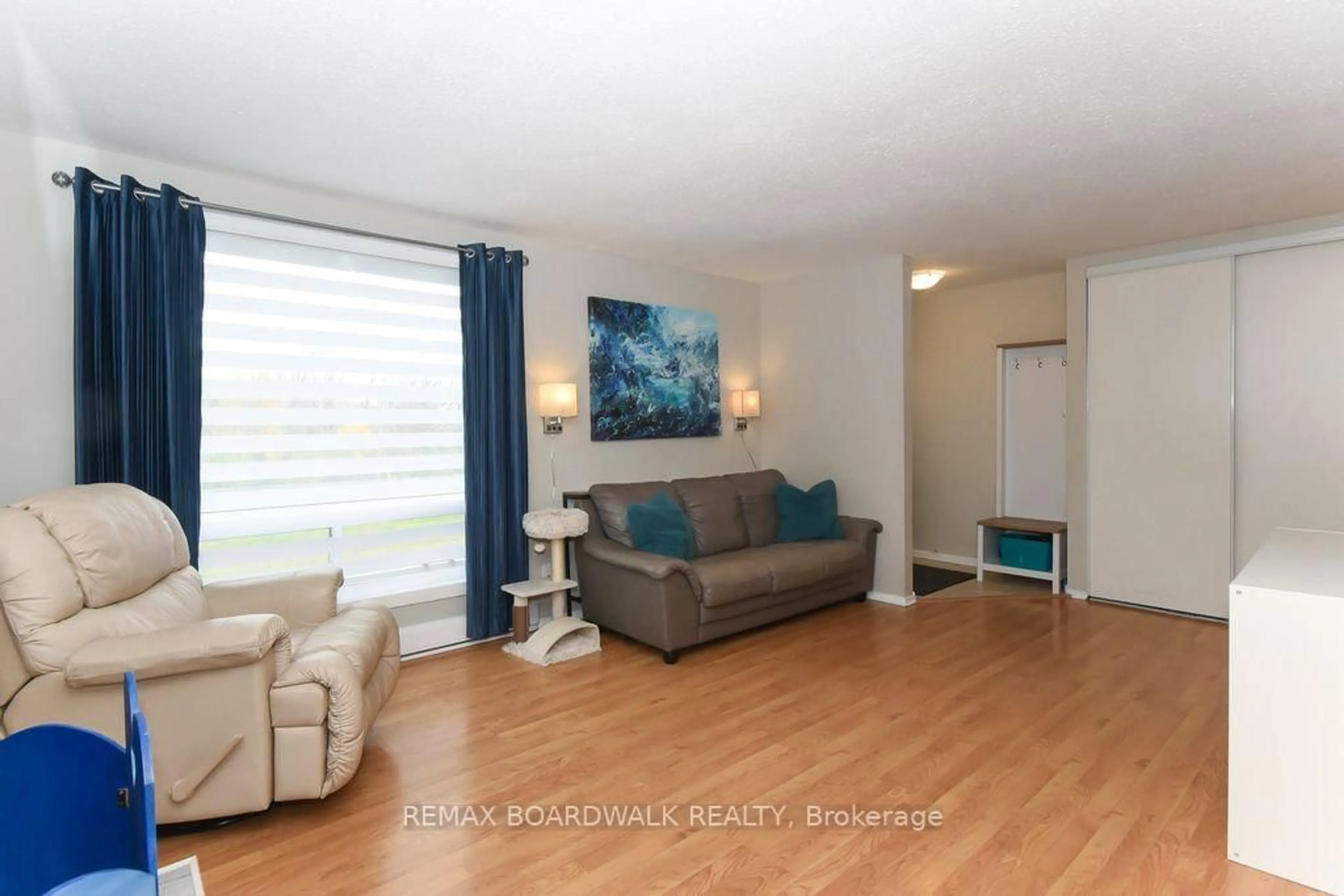 Living room with furniture, wood/laminate floor for 758 St-Andre Dr, Ottawa Ontario K1C 4S6