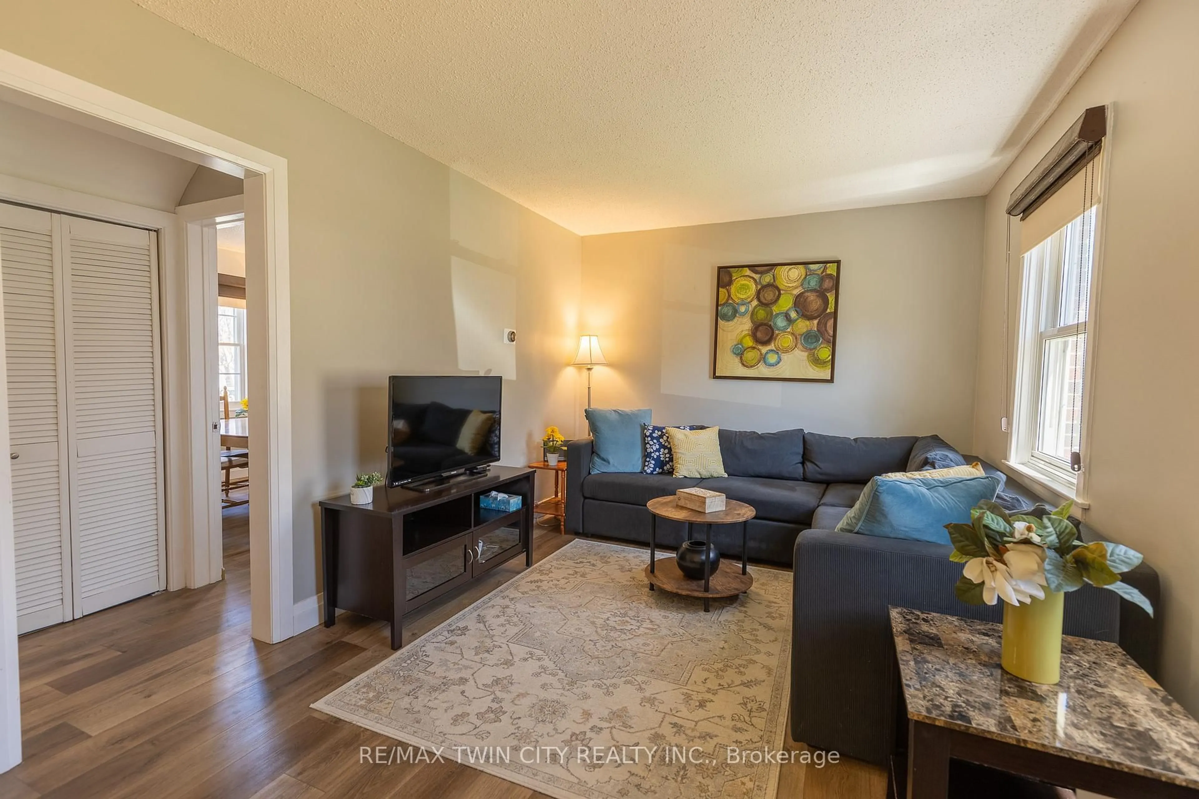 Living room with furniture, wood/laminate floor for 110 Lorne Cres, Kitchener Ontario N2M 3Y5