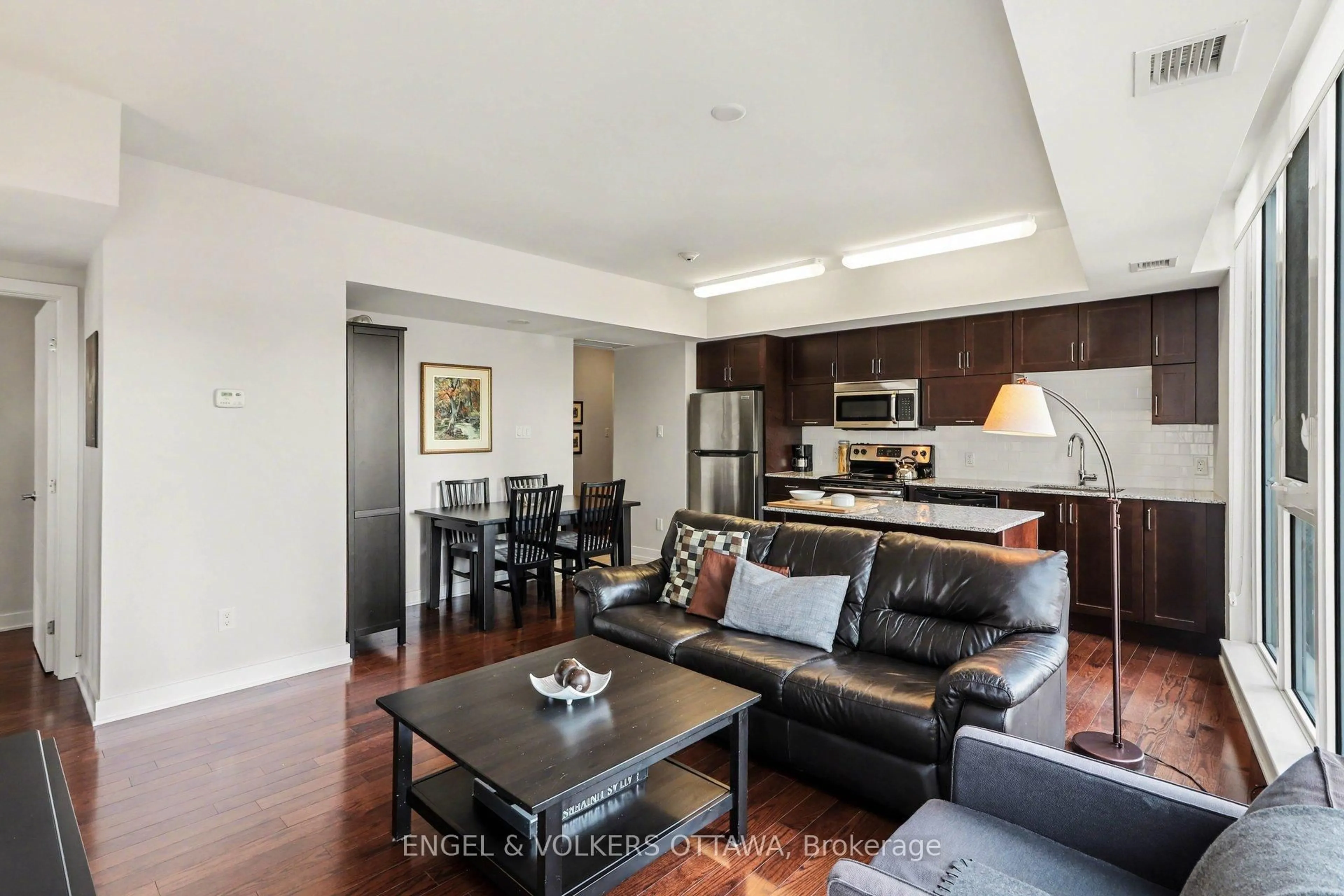 Living room with furniture, wood/laminate floor for 179 Metcalfe St #701, Ottawa Ontario K2P 0W1