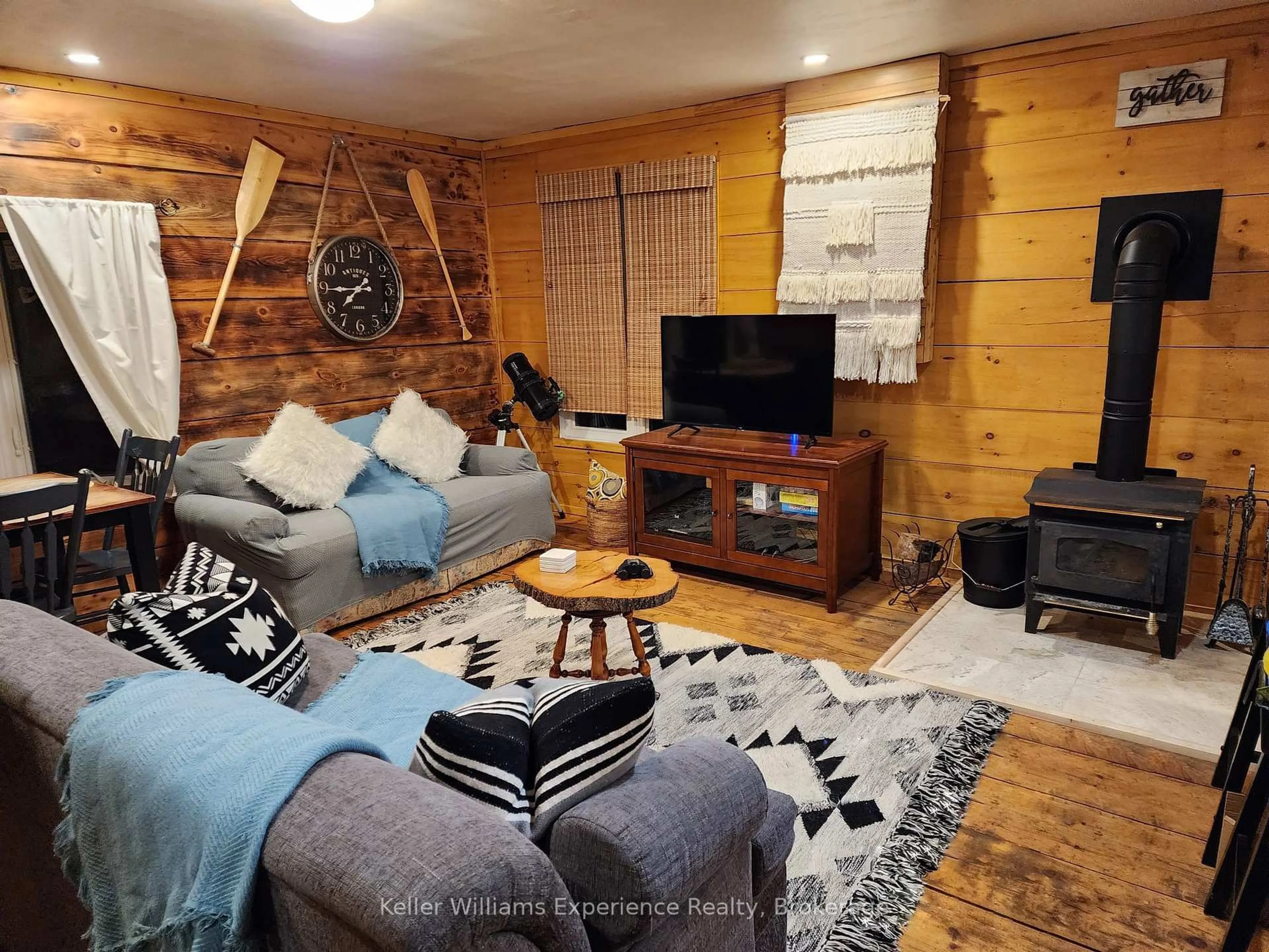 Living room with furniture, wood/laminate floor for 76 Machar River Rd, Machar Ontario P0A 1X0