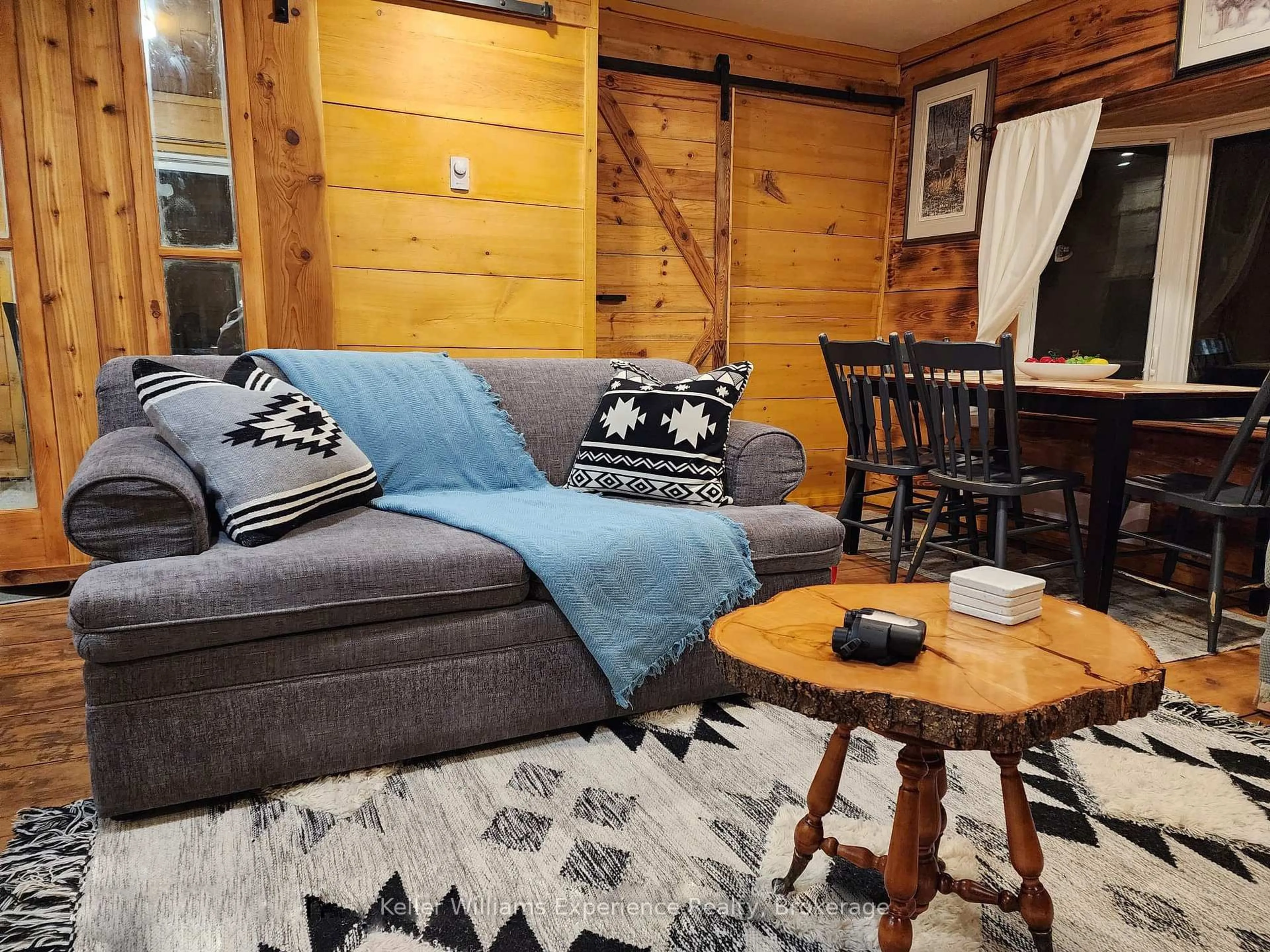 Living room with furniture, wood/laminate floor for 76 Machar River Rd, Machar Ontario P0A 1X0