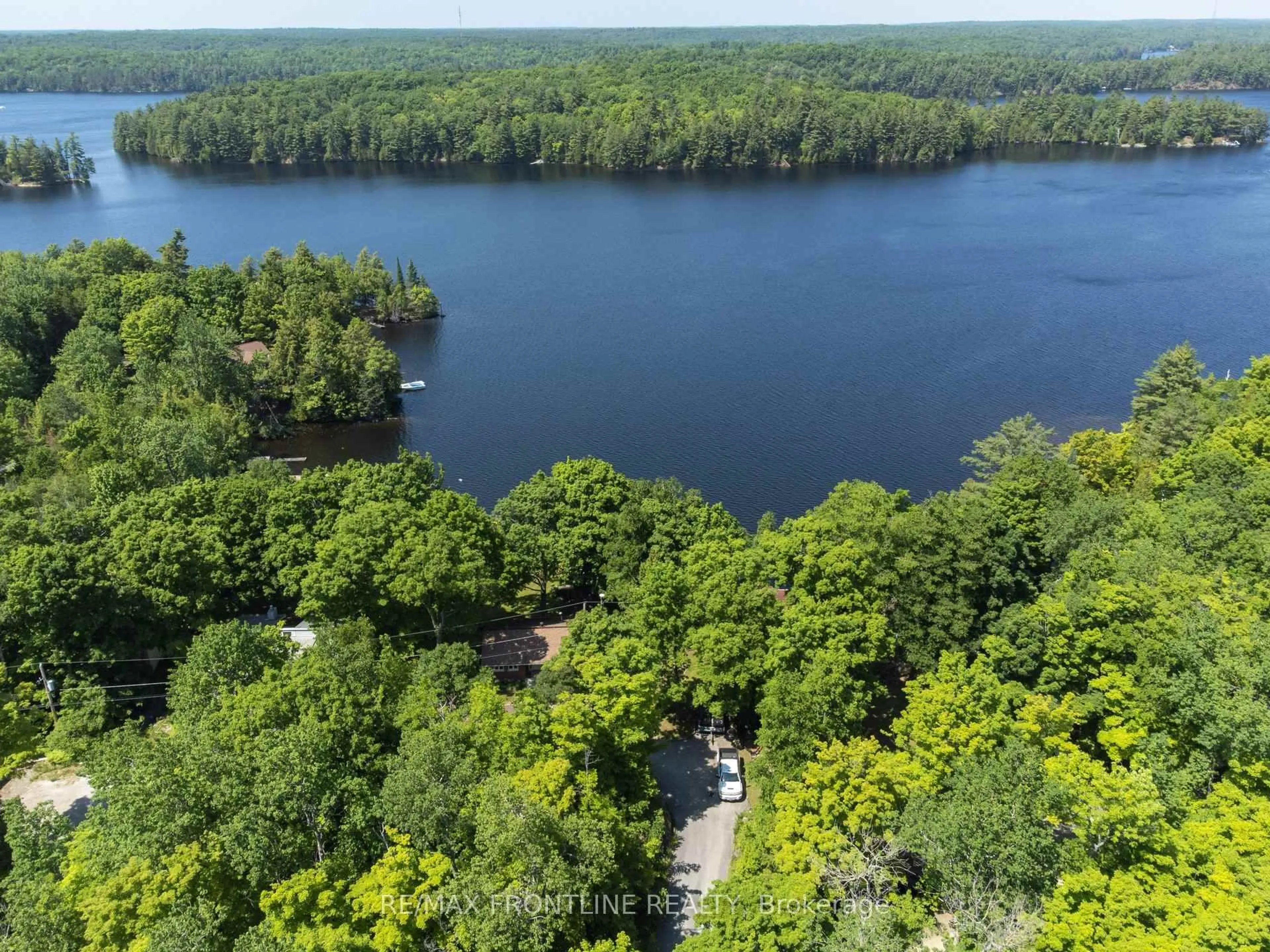 A pic from outside/outdoor area/front of a property/back of a property/a pic from drone, water/lake/river/ocean view for 1047 Country Lane, Frontenac Ontario K0H 2P2