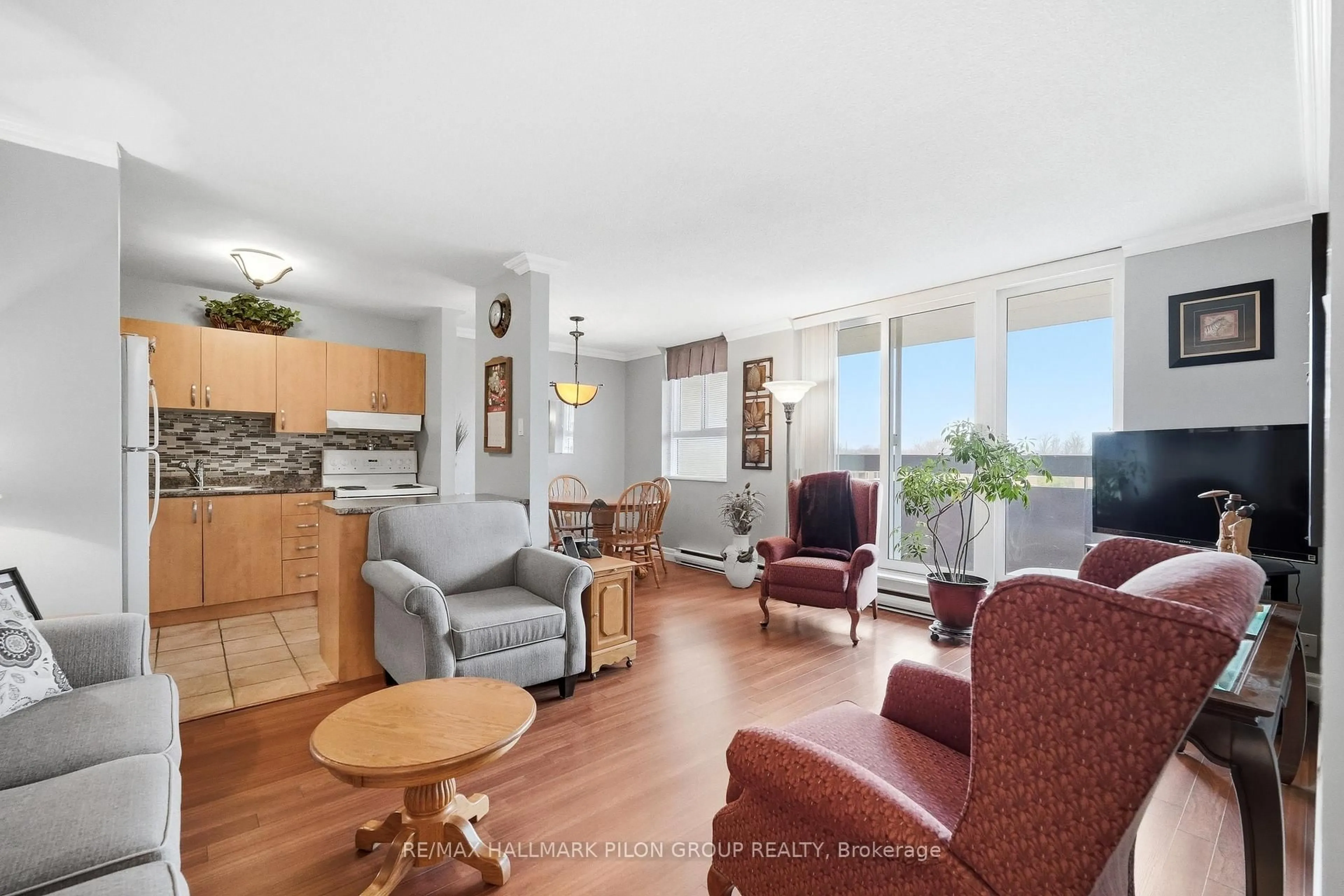 Living room with furniture, wood/laminate floor for 2000 Jasmine Cres #508, Ottawa Ontario K1J 8K4