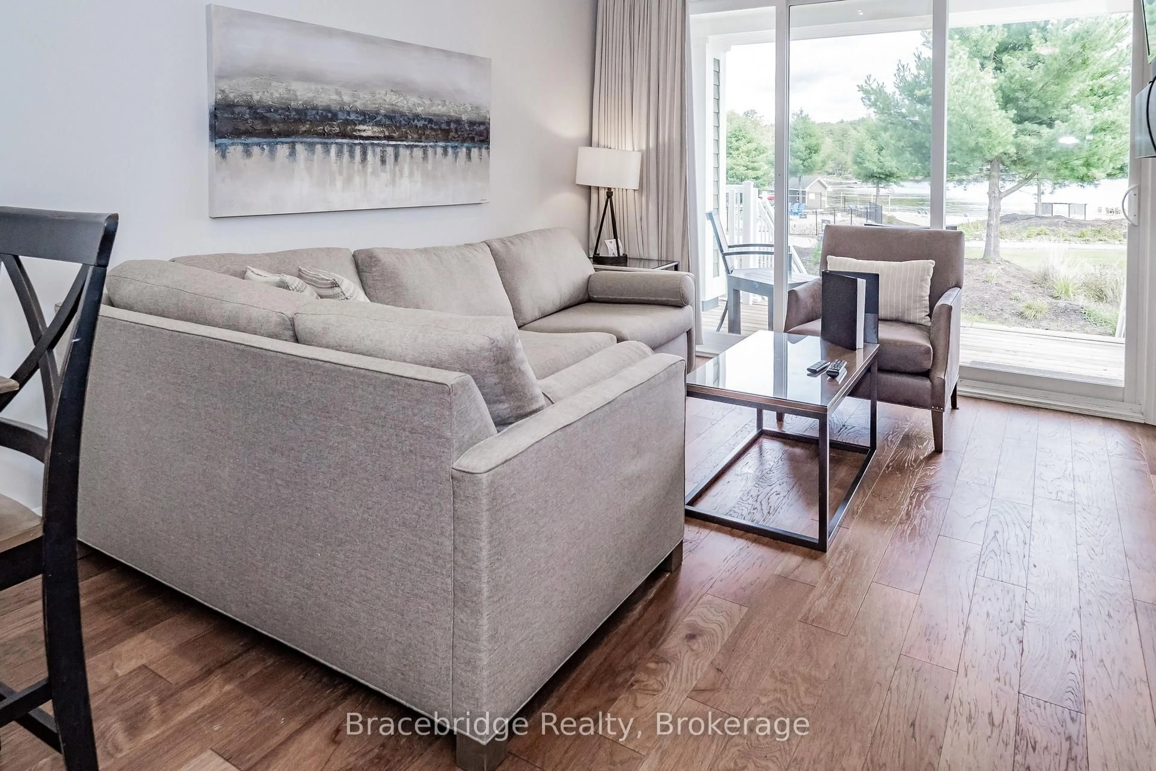 Living room with furniture, wood/laminate floor for 1869 Muskoka Rd 118 Highway #BHV-C101-A&B, Muskoka Lakes Ontario P1L 1W8