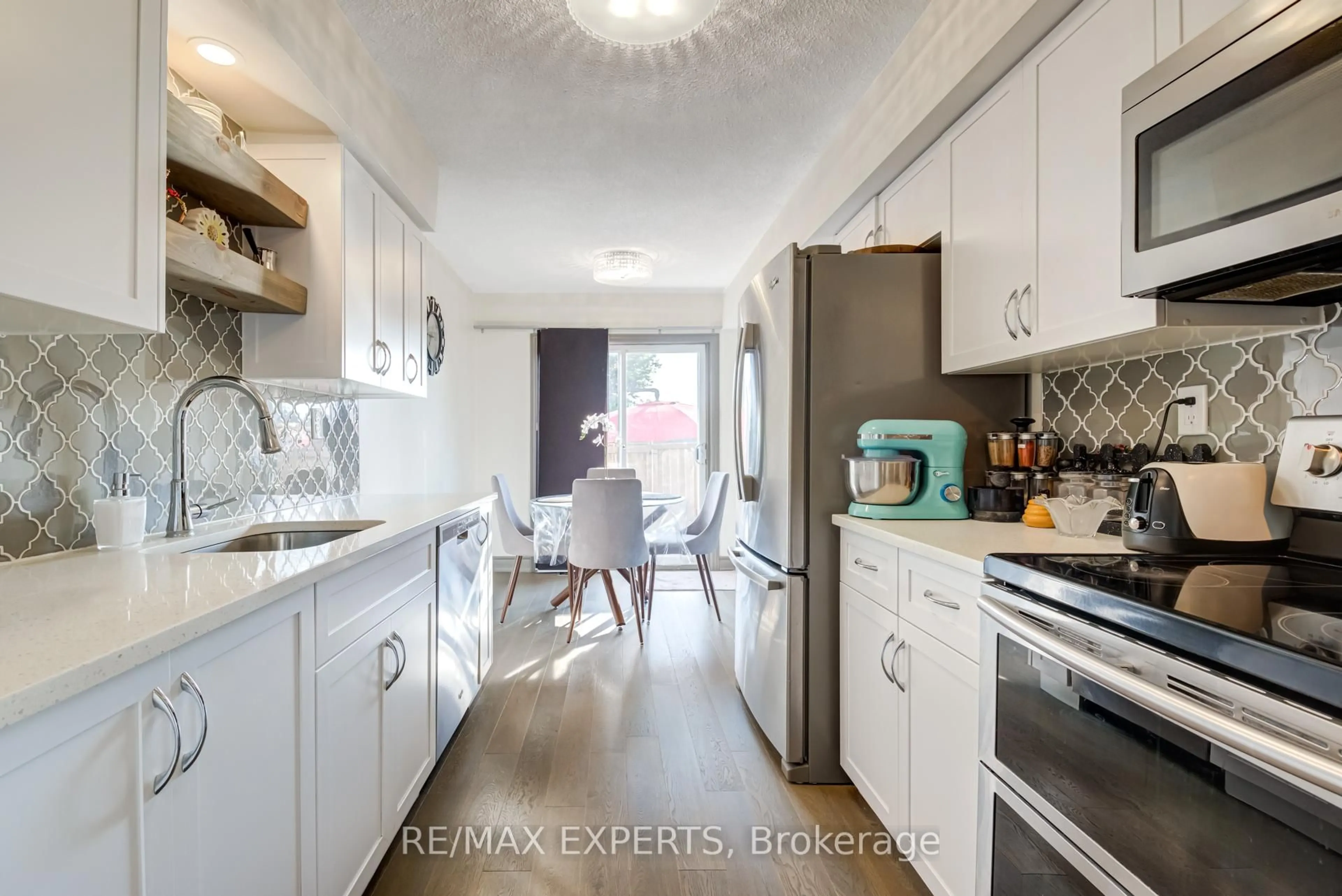 Open concept kitchen, wood/laminate floor for 766 Walter St #J, Cambridge Ontario N3H 4P3